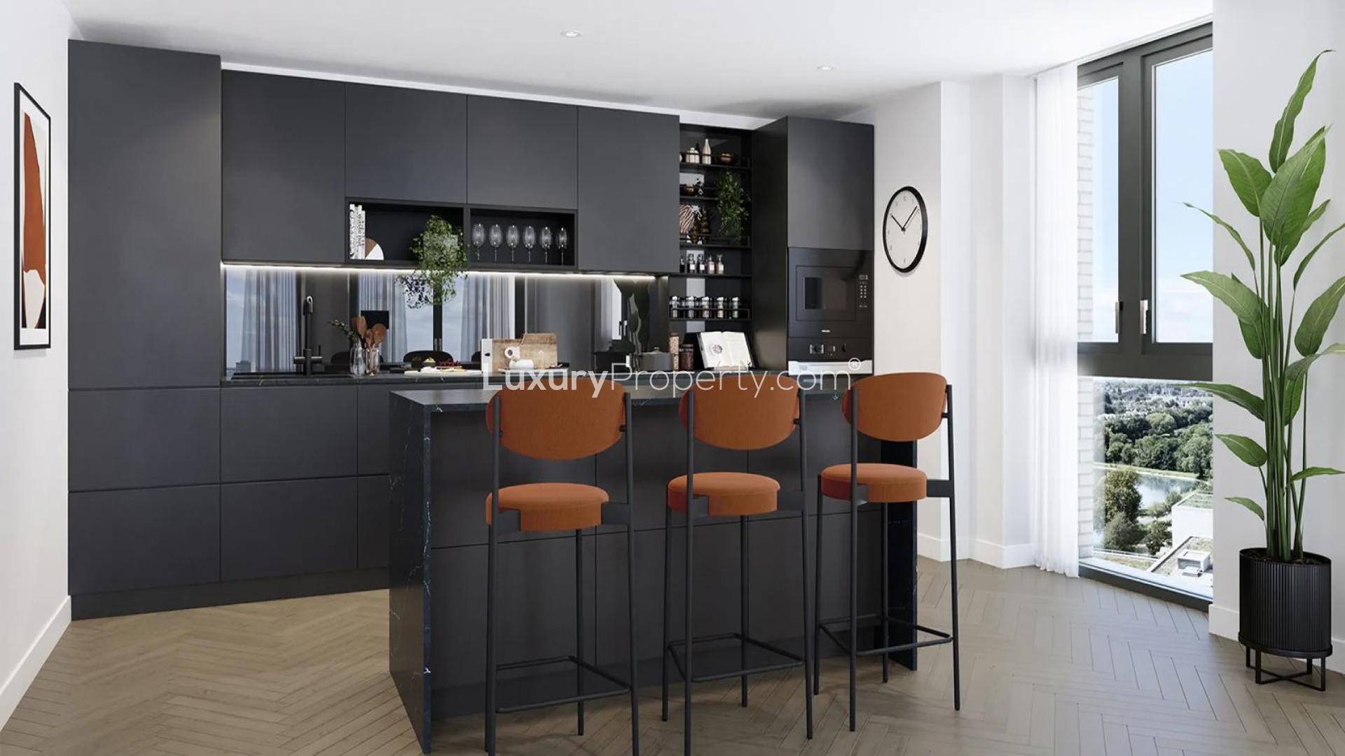 Balcony view from Emperor Point apartment in Woodberry Down, overlooking London skyline and lake