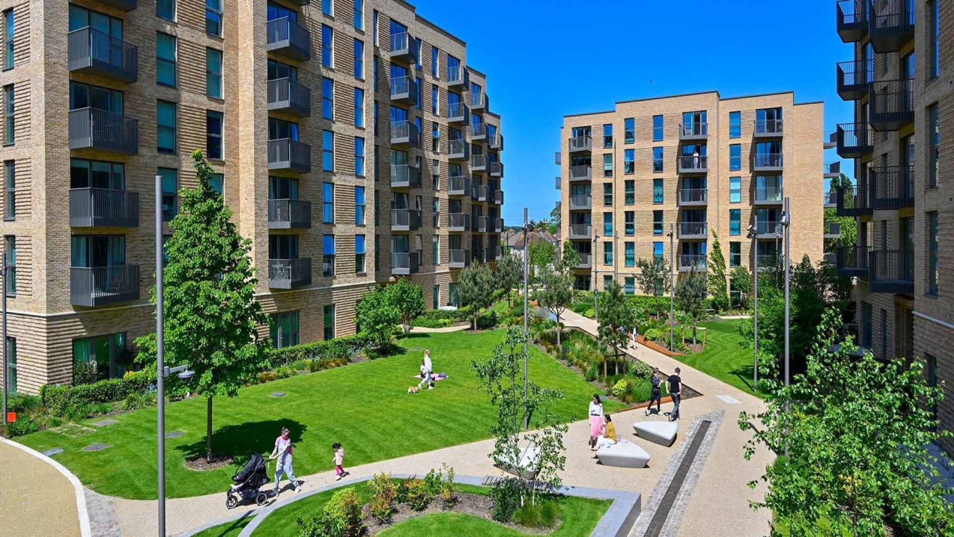 "Stylish one-bedroom apartment interior at Horlicks Quarter, London, featuring modern decor and dining area.",Modern apartment buildings with green courtyard in Horlicks Quarter, London, for sale