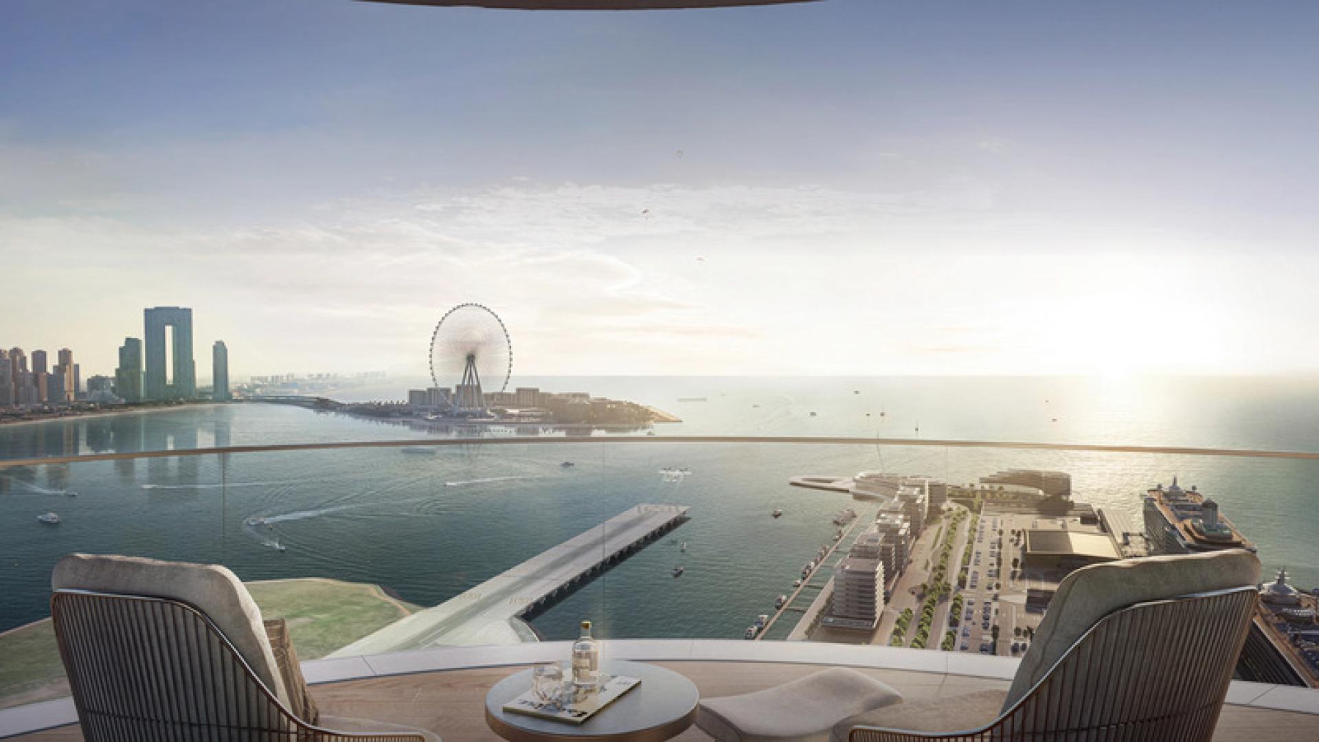 "Beachfront view of Emaar Bayview apartments and beachgoers at Address Dubai Harbour.",Stunning sea view from 1-bedroom apartment balcony in Emaar Beachfront, Dubai Harbour