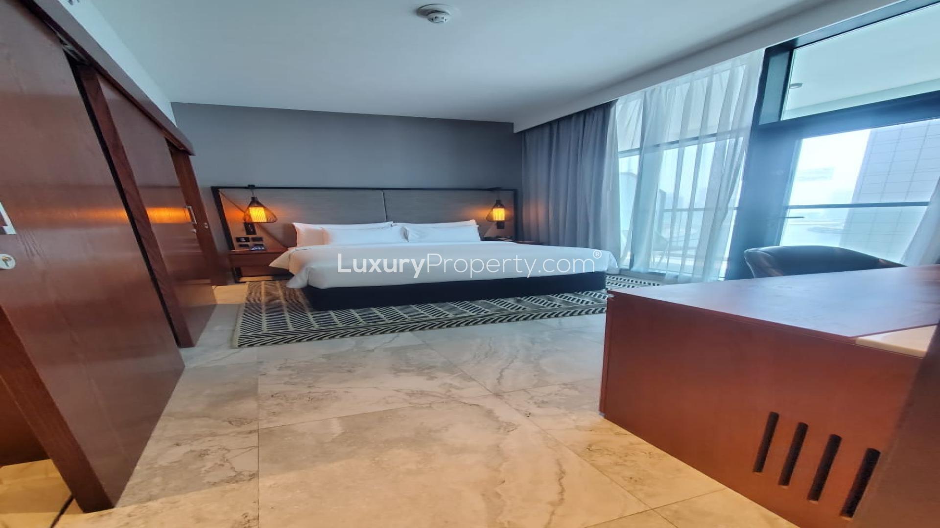 N/A,Modern bedroom in Business Bay apartment for sale, featuring large windows and elegant decor