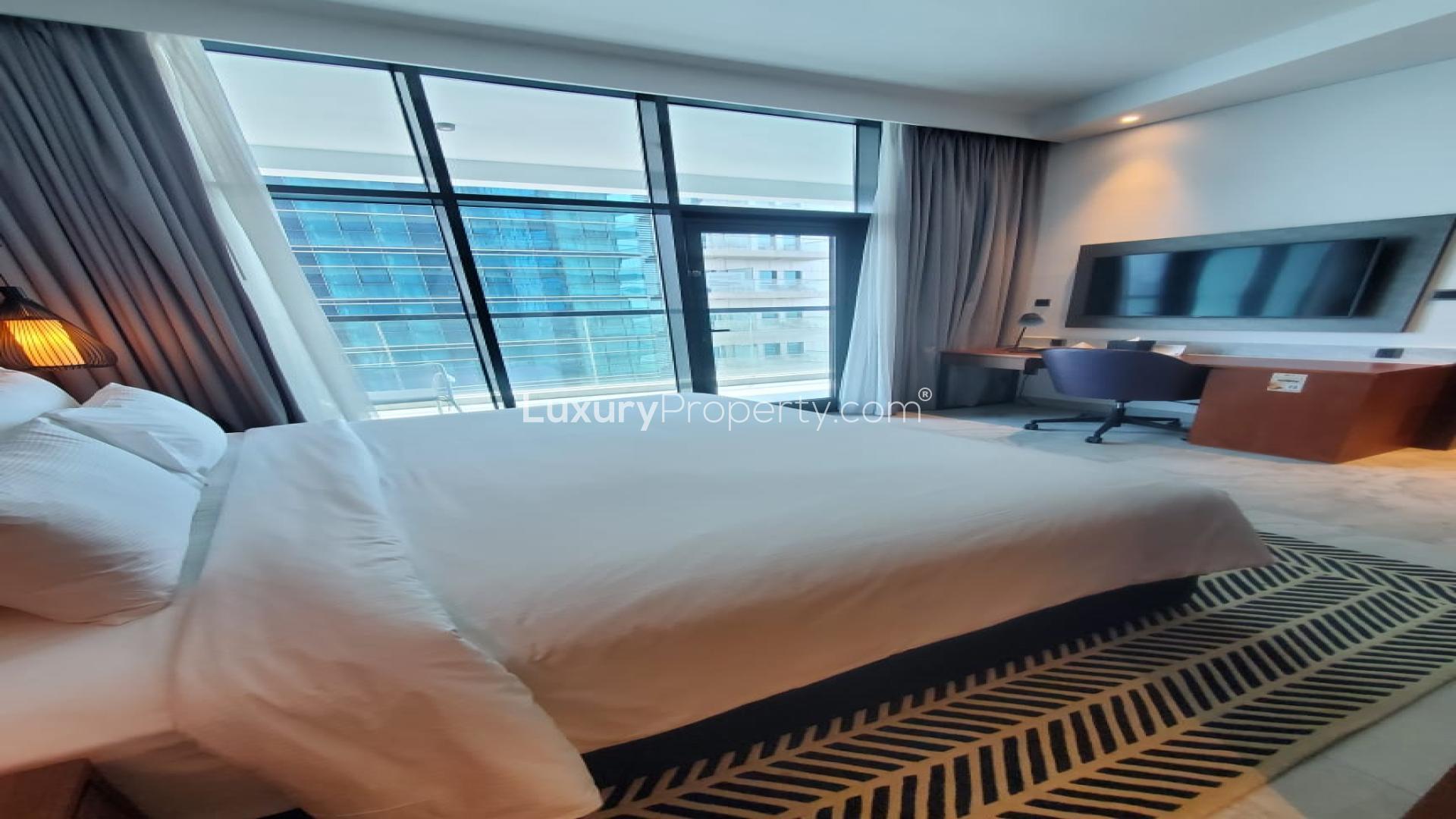Modern bedroom in Business Bay apartment for sale, featuring sleek design and cozy ambiance