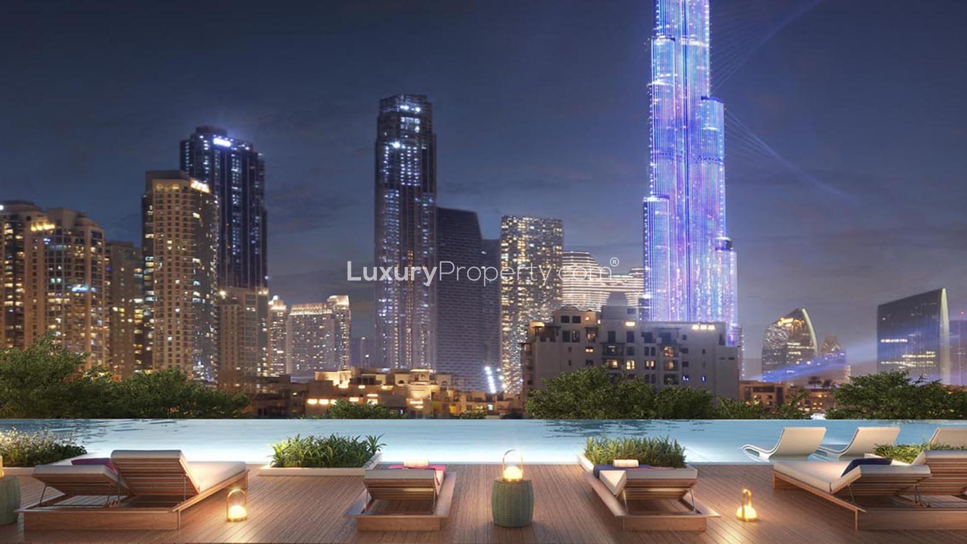 Night view of W Residences apartment tower in Downtown Dubai with city skyline