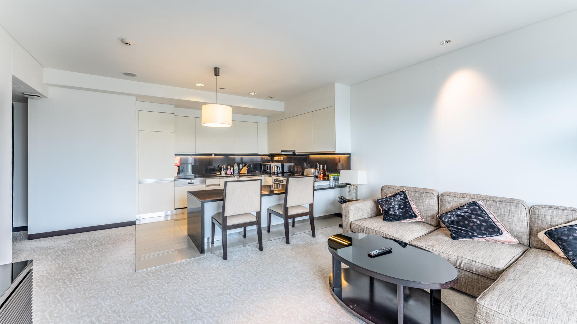 Modern living room in Dubai Marina apartment with city skyline view from balcony