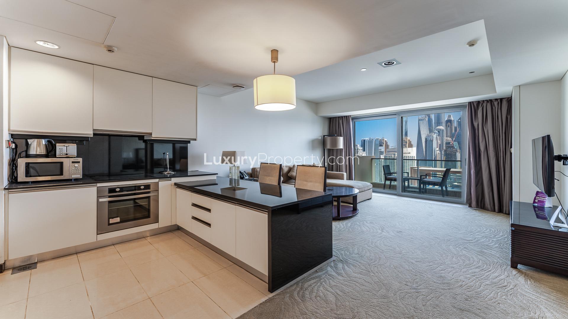 Dubai Marina apartment living room with city view, modern furniture, and balcony access