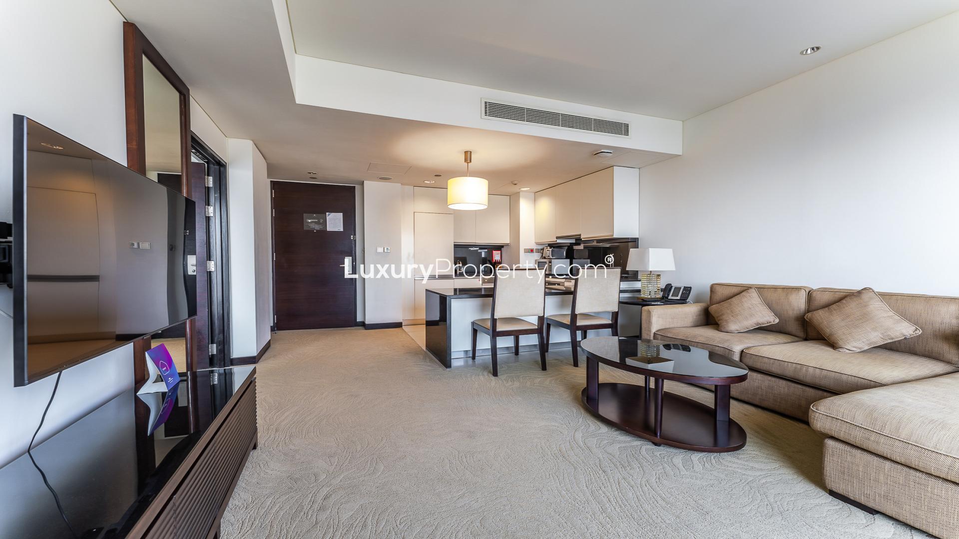 Modern living room in Dubai Marina apartment, featuring a cozy sofa and elegant decor