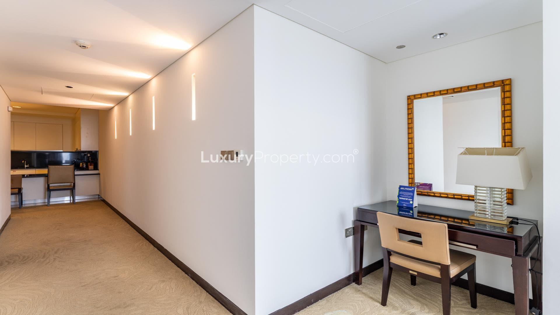 Modern living room in Dubai Marina apartment, featuring sofa and TV, JW Marriott Hotel