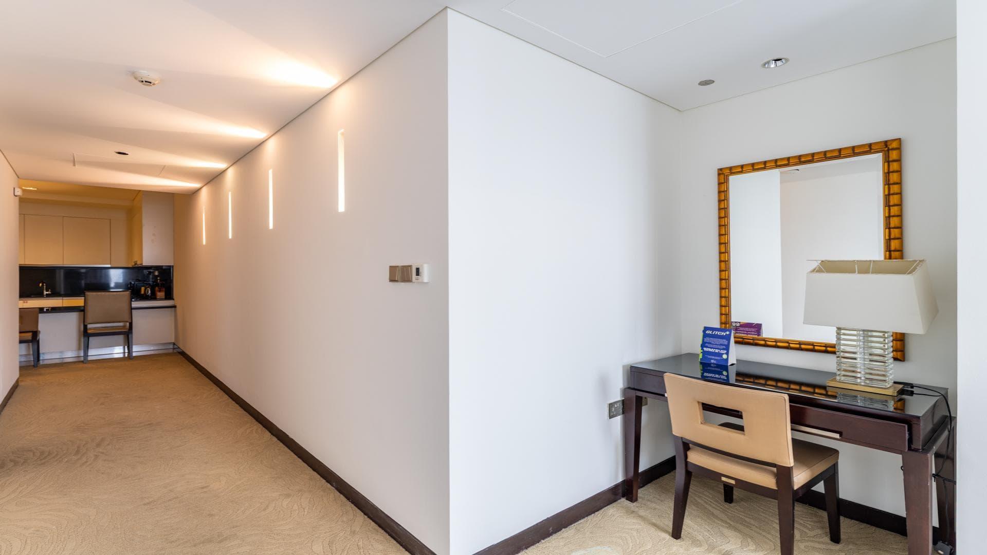 Modern living room in Dubai Marina apartment, featuring sofa and TV, JW Marriott Hotel