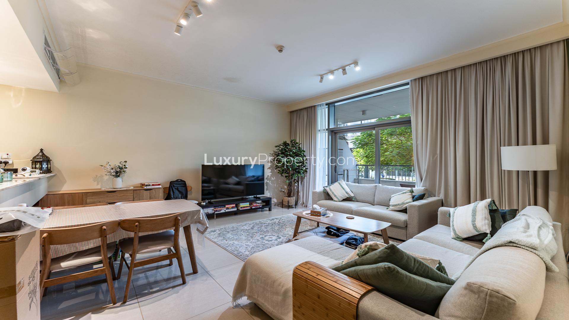 Modern living room in Mulberry apartment, Dubai Hills Estate, with cozy furnishings and natural light