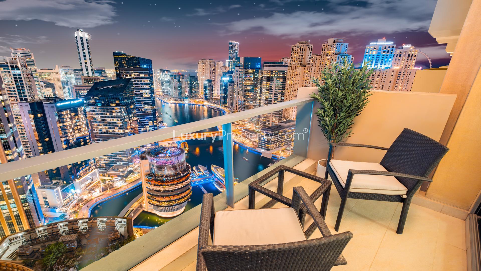 Dubai Marina skyline at night with illuminated skyscrapers and waterfront, near JW Marriott Hotel