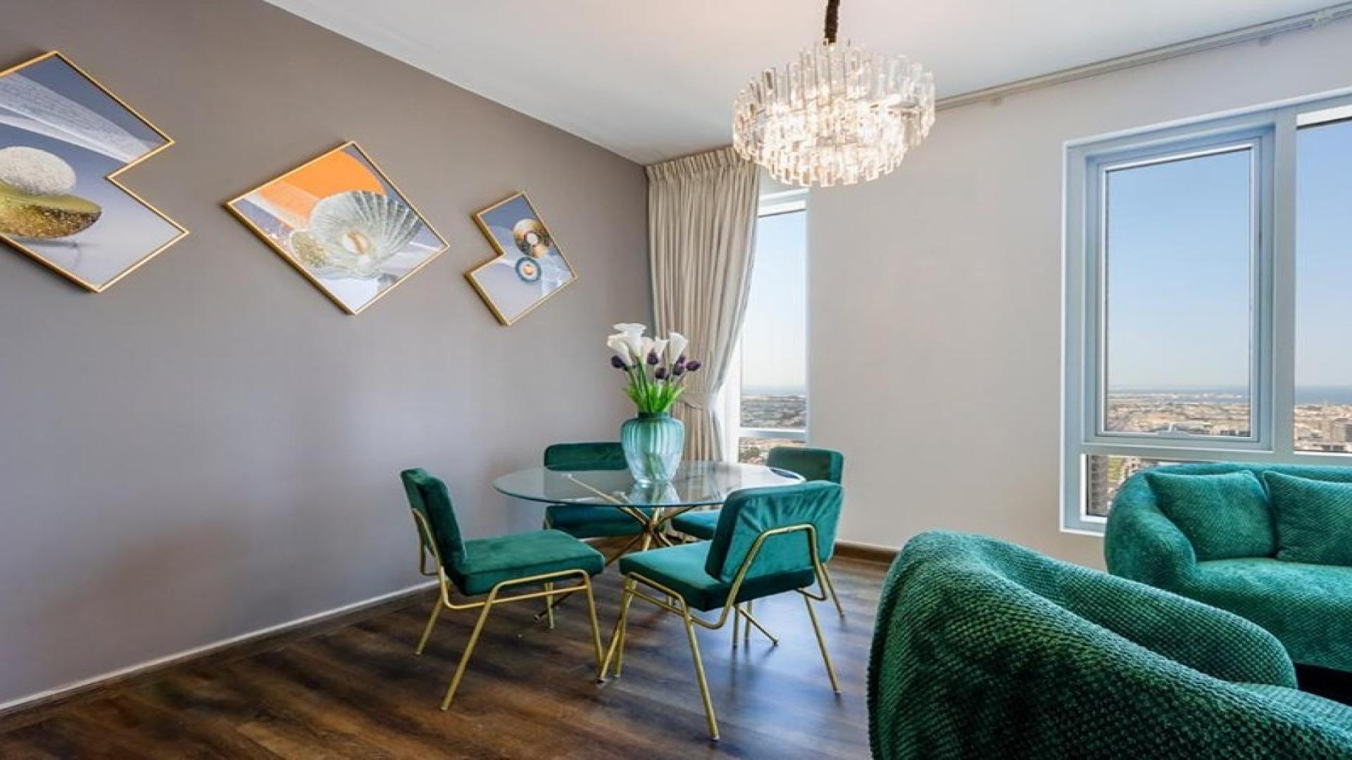 Luxurious living room in The Lofts Central apartment, Downtown Dubai, featuring elegant chandeliers