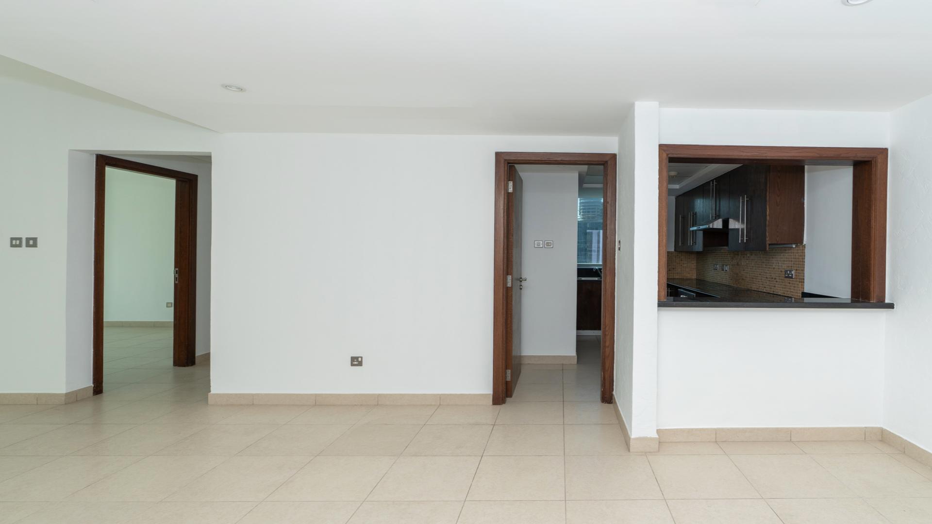 Spacious living area in 8 Boulevard Walk apartment, Downtown Dubai, large windows, tiled floor