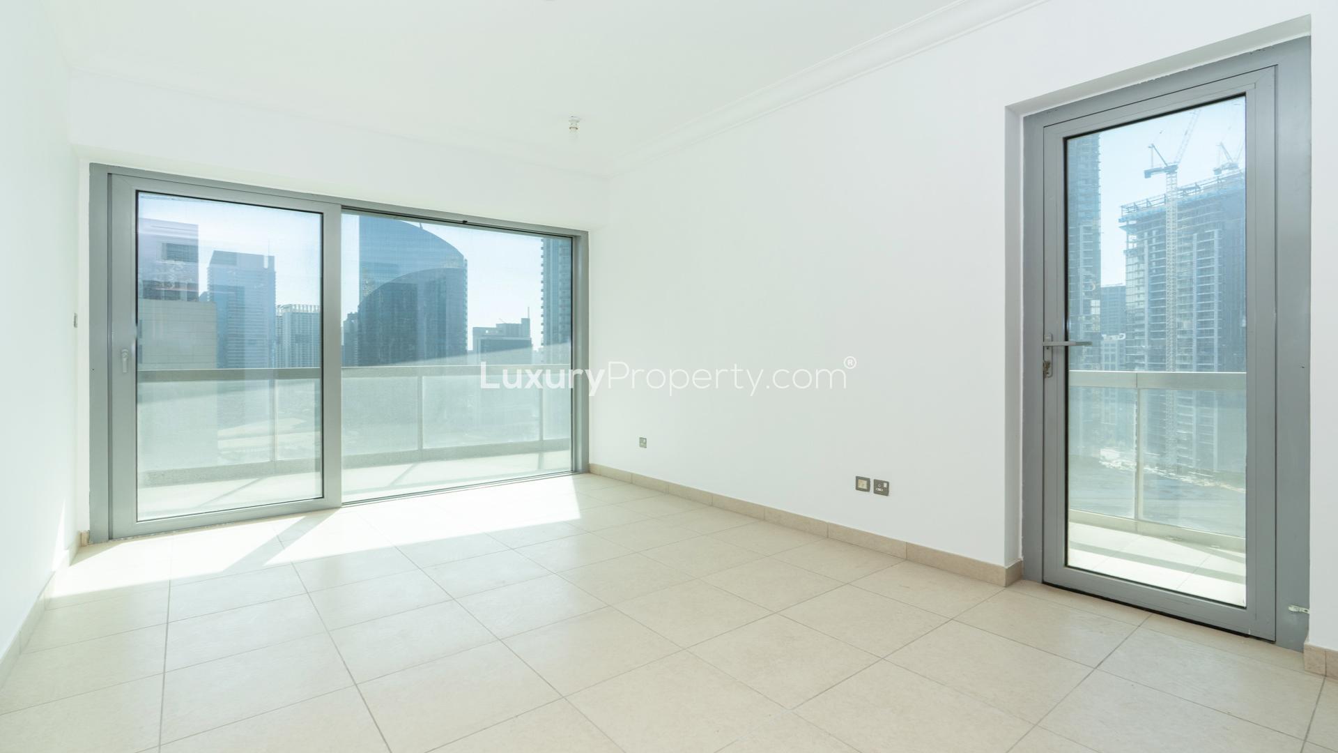 Spacious living area in 8 Boulevard Walk apartment, Downtown Dubai, large windows, tiled floor
