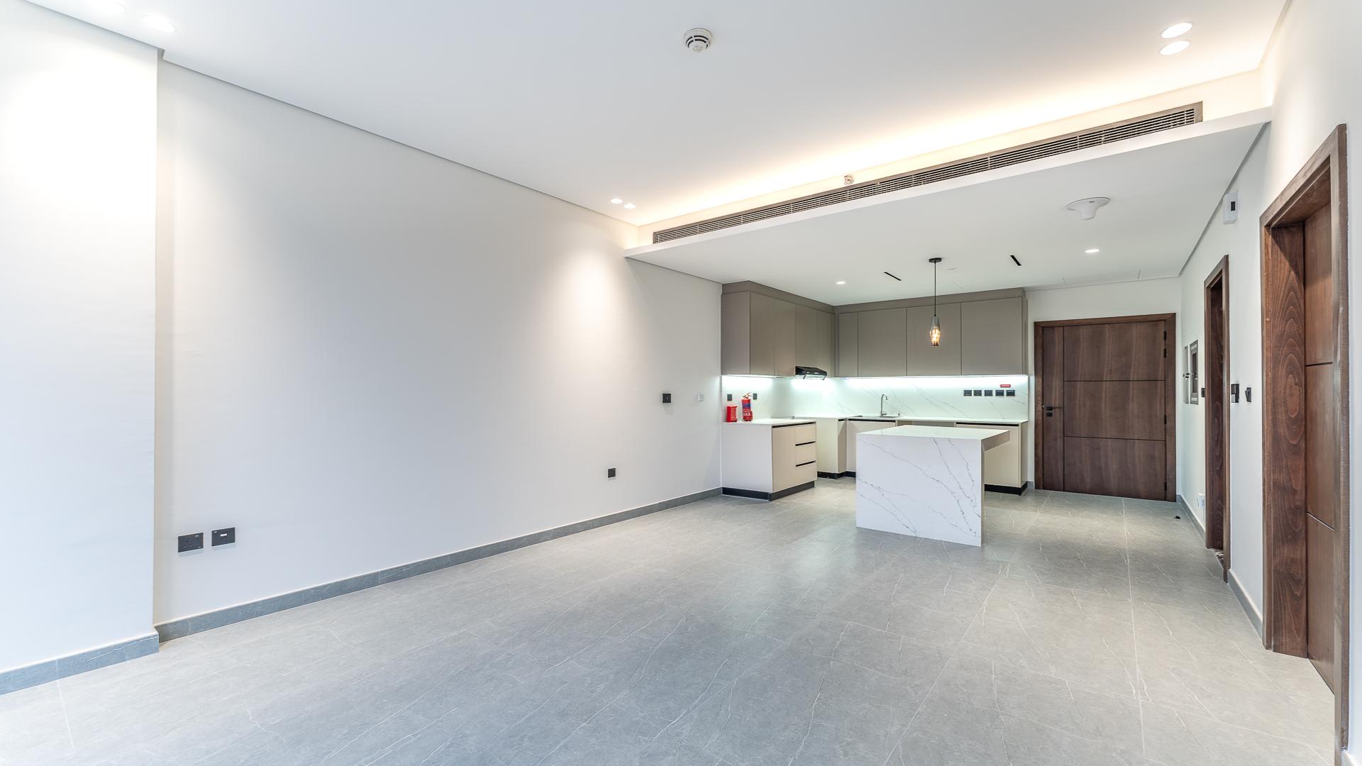 Modern kitchen in Arista One apartment, Al Satwa, featuring sleek cabinetry and island