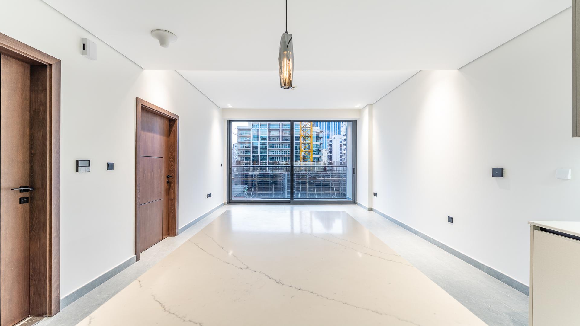 Modern living area with large windows in Arista One apartment