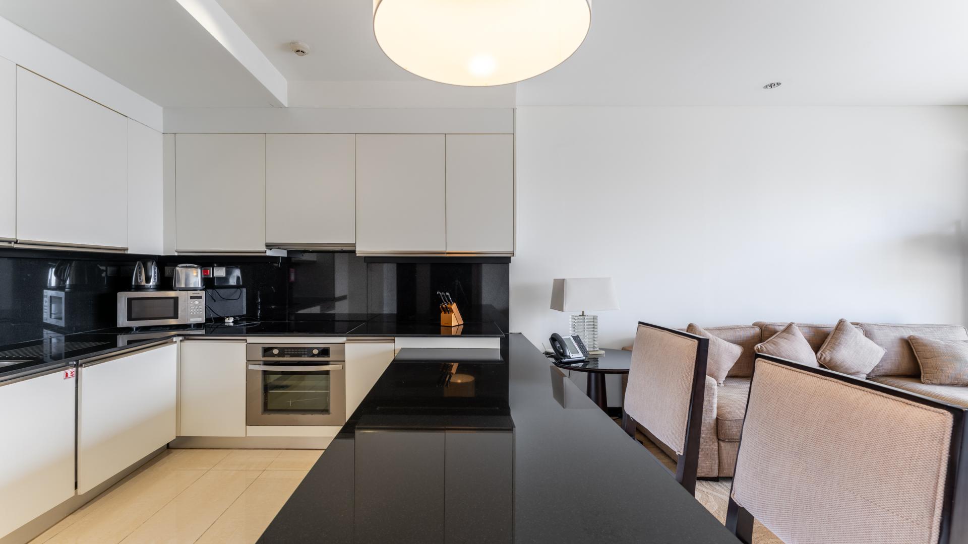 Modern open-plan living room and kitchen in Dubai Marina apartment for sale, JW Marriott Hotel