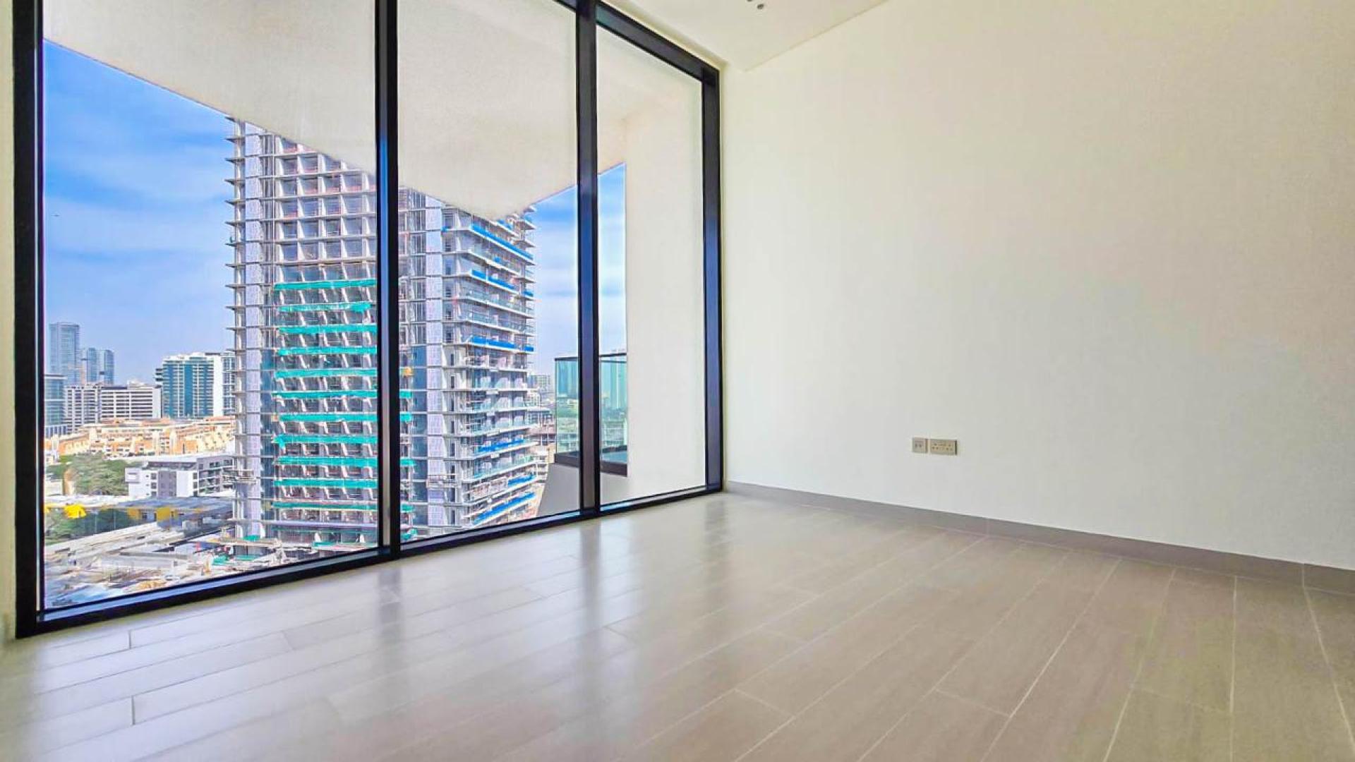 "Spacious JVC apartment with marina and park view, large windows in Binghatti Royale.",Spacious JVC apartment balcony with marina and park views in Binghatti Royale