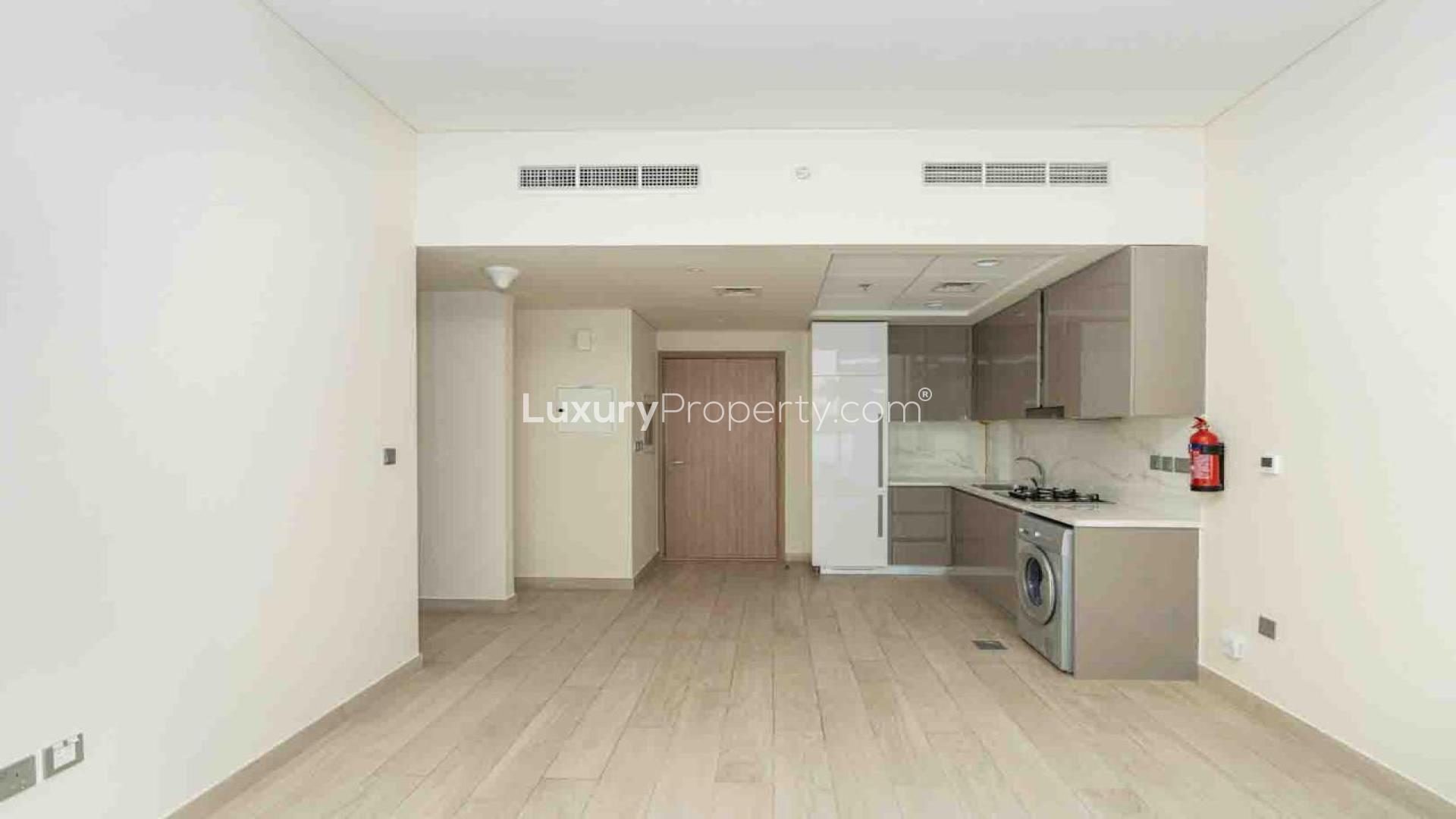 Bright, spacious living area with large windows in Azizi Riviera apartment, Meydan