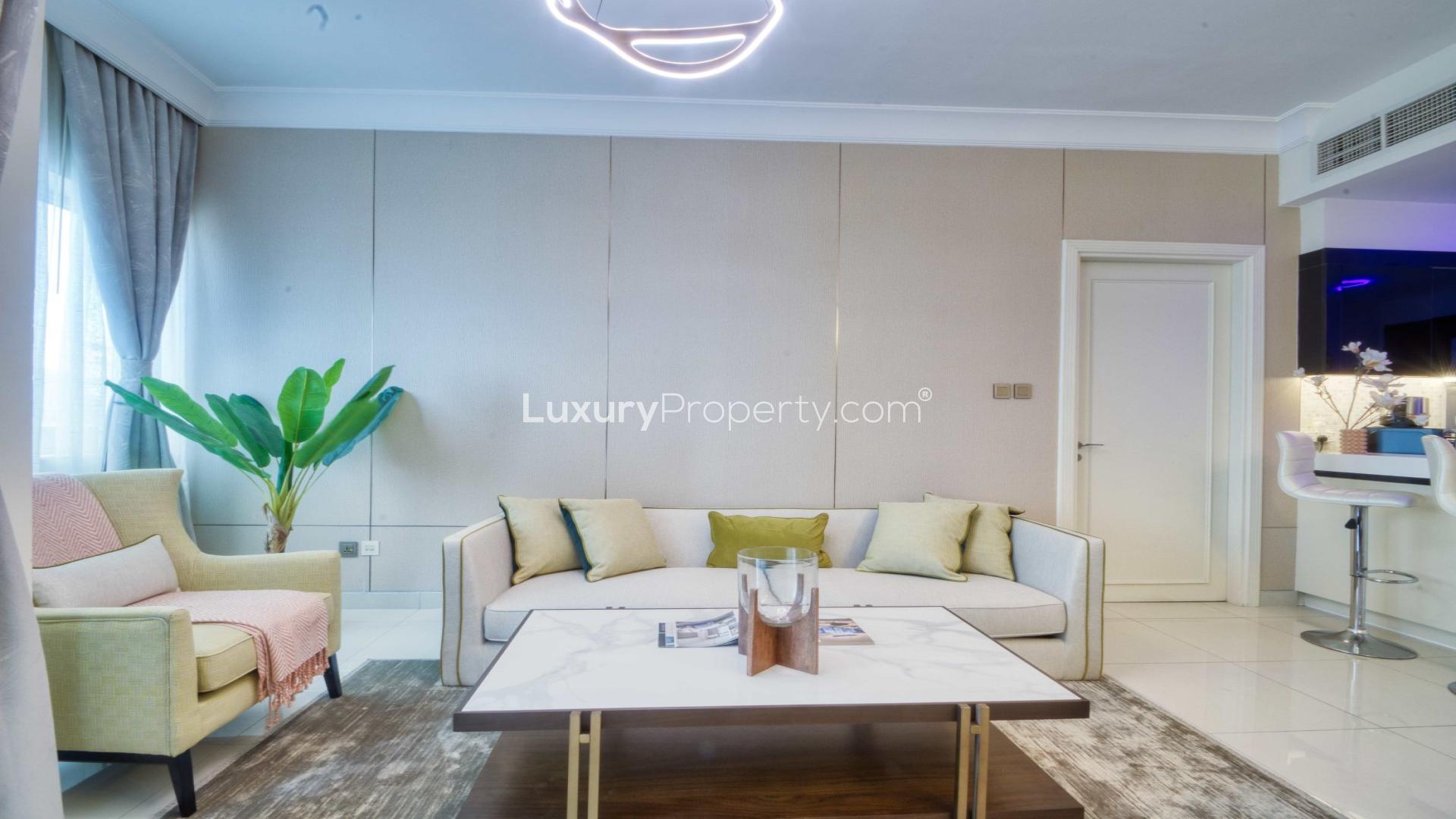 Fully furnished one-bedroom apartment living area in Damac Maison for sale