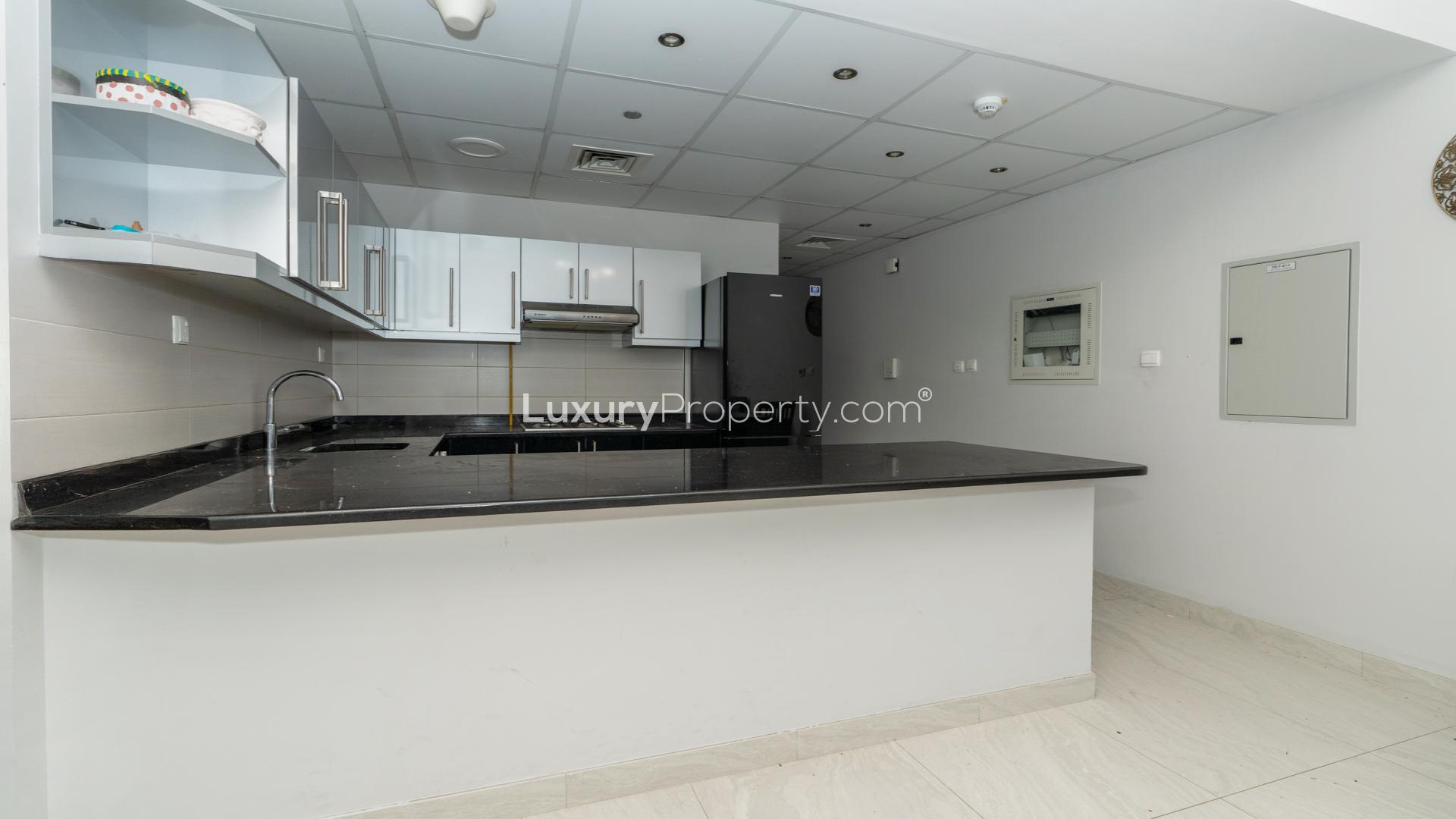 "Spacious furnished kitchen and dining area in Business Bay apartment for sale, LP48650.",Modern kitchen in fully furnished apartment, Elite Business Bay, ideal for rental income
