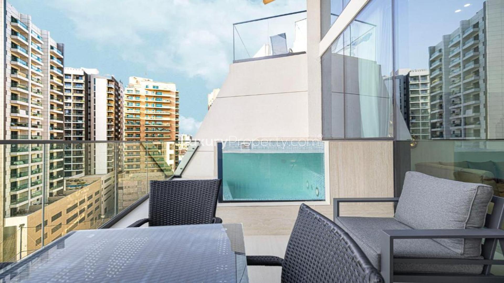"Private pool with community view in Binghatti Phantom apartment, JVC, for sale.","Luxury apartment balcony with private pool and community view in JVC Binghatti Phantom.","Modern kitchen in luxury 1-bedroom apartment for sale, Binghatti Phantom, JVC community view.",Modern kitchen in luxury 1-bedroom apartment, Binghatti Phantom, JVC