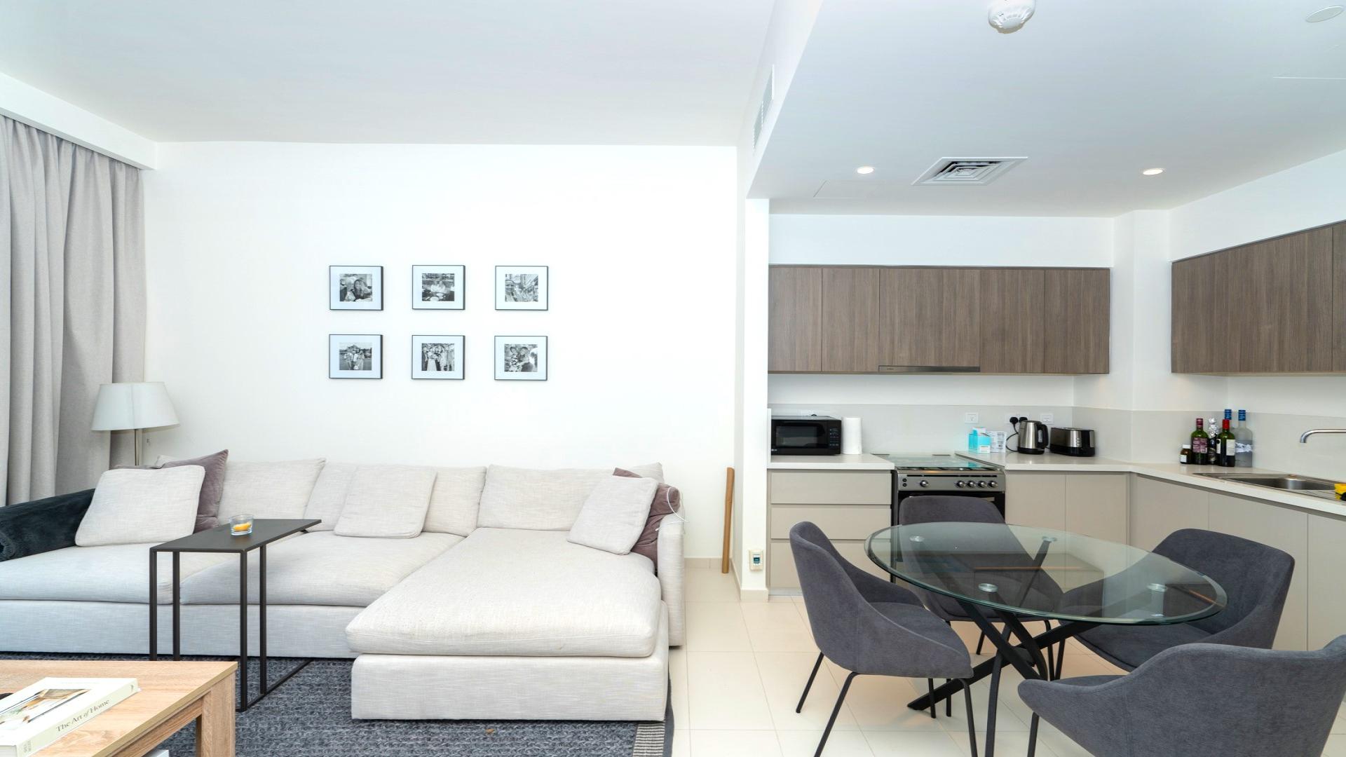 Balcony view of modern skyscrapers in Park Ridge, Dubai Hills Estate, blue sky backdrop