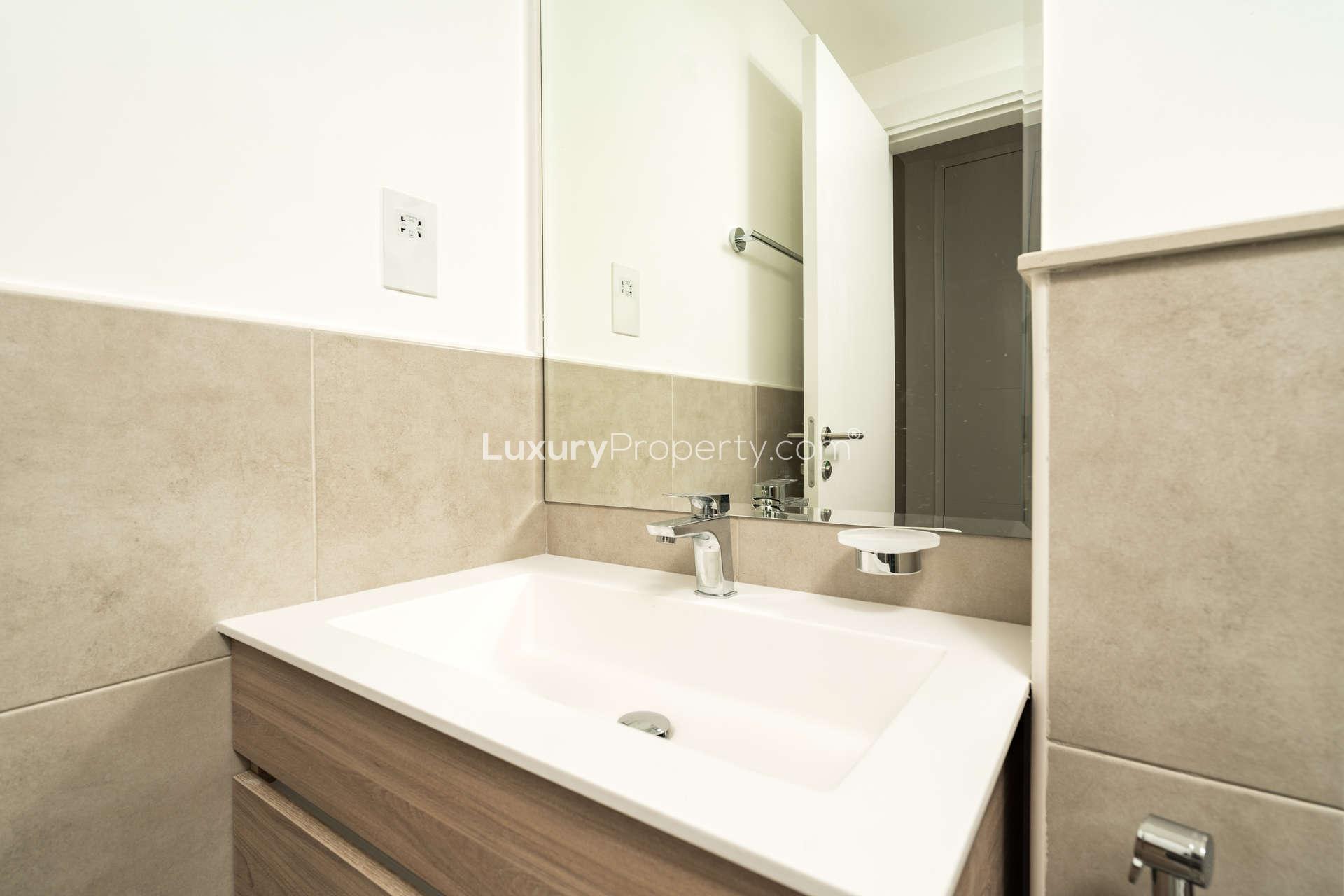 Spacious living area with balcony view in Alandalus, Jumeirah Golf Estates apartment for sale