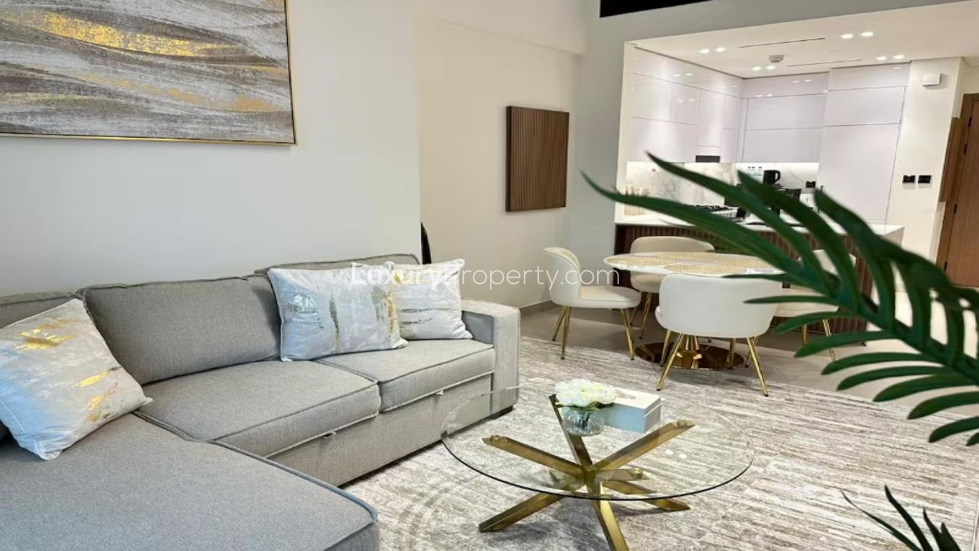 Modern living room in Jumeirah Village Circle apartment, featuring city views and stylish decor