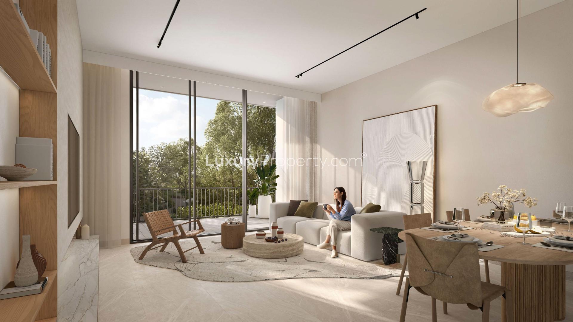 "Balcony view of lush forest and city skyline from Ghaf Woods apartment in Dubai Land.",Modern living room in one-bedroom apartment, Cilia, Ghaf Woods, Dubai Land, with balcony view