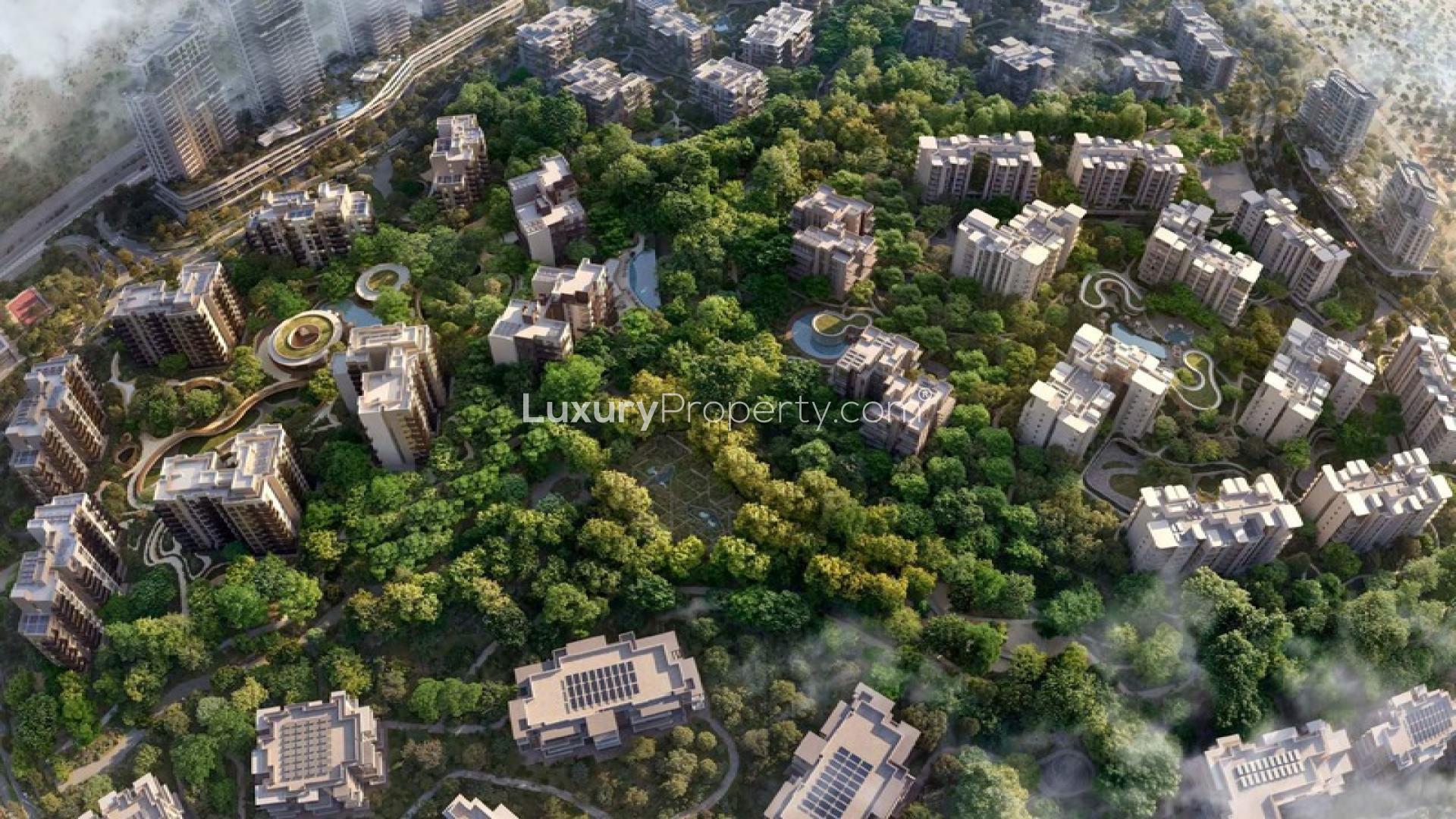 Aerial view of lush Ghaf Woods residential community in Dubai Land, showcasing modern apartments