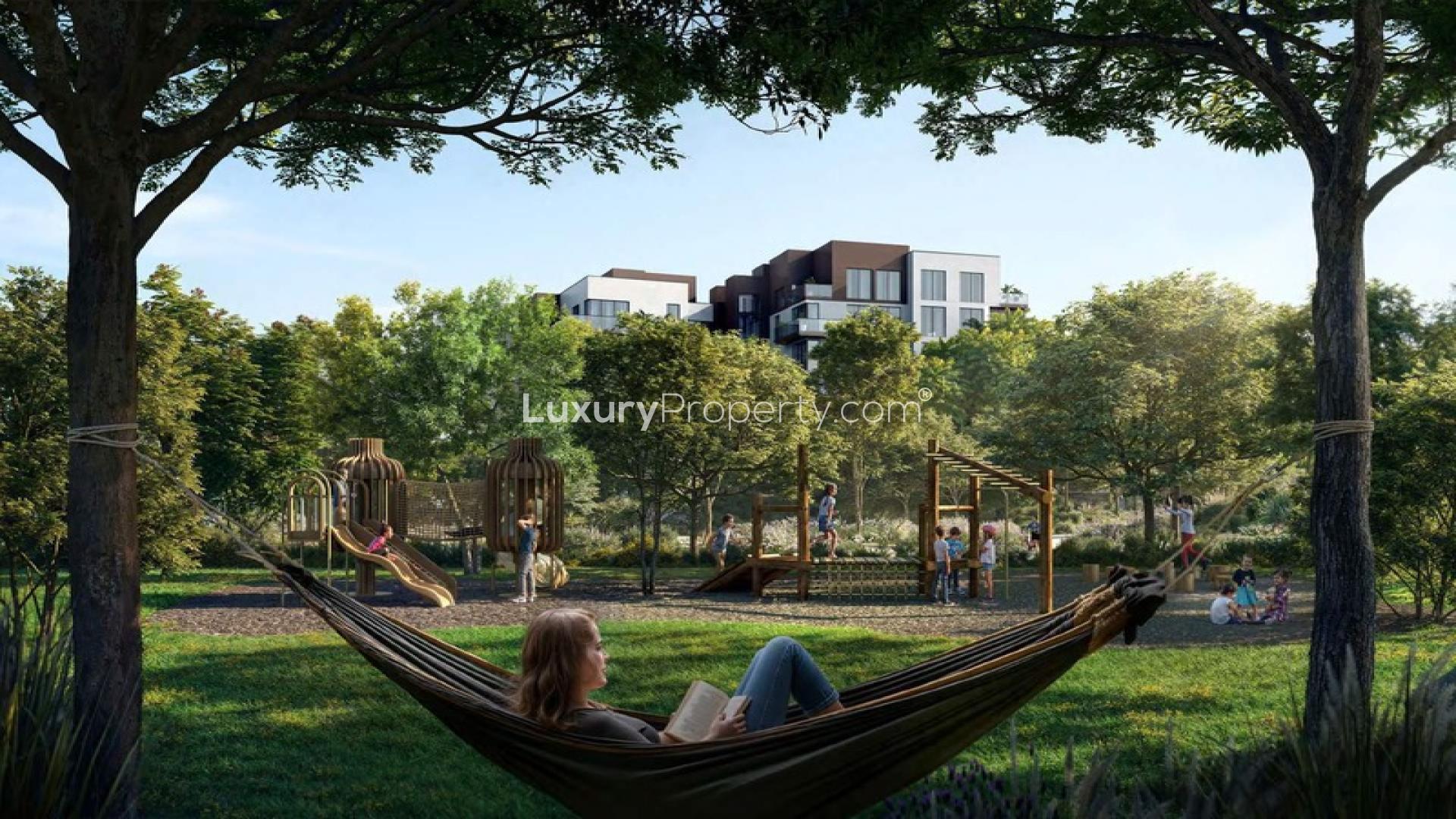 Hammock view of playground and greenery at Ghaf Woods, Dubai Land apartment community