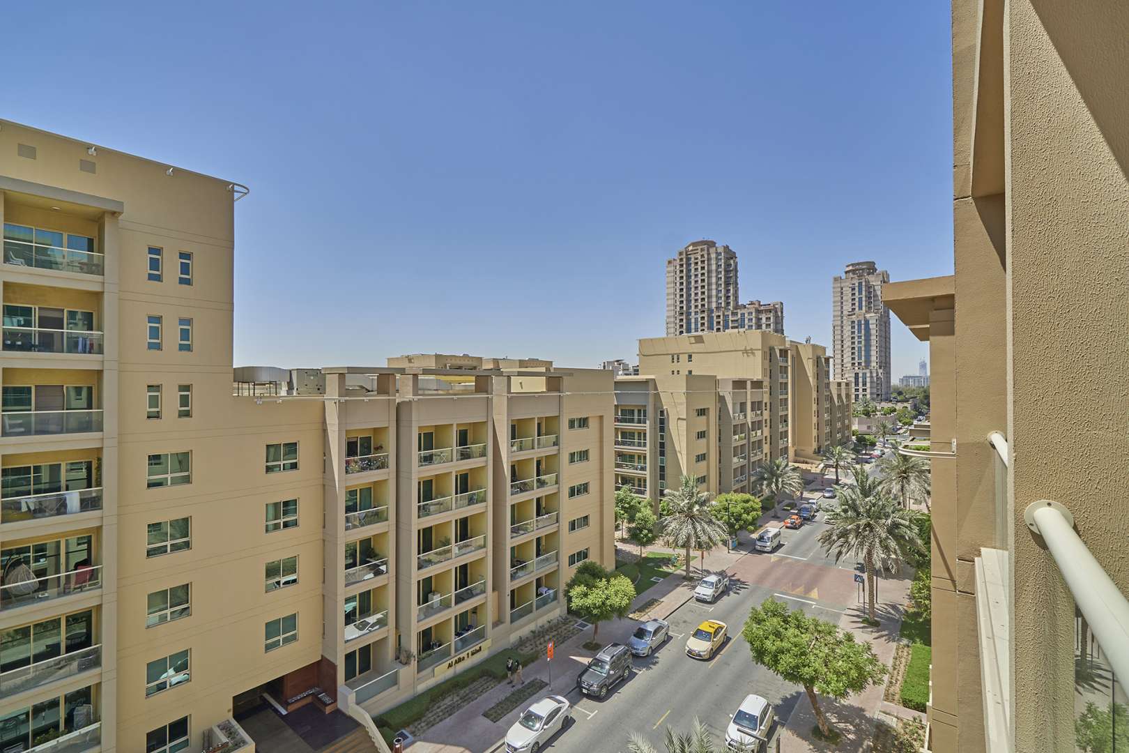 Exterior view of Al Ghozlan apartments in The Greens, featuring modern architecture and cityscape