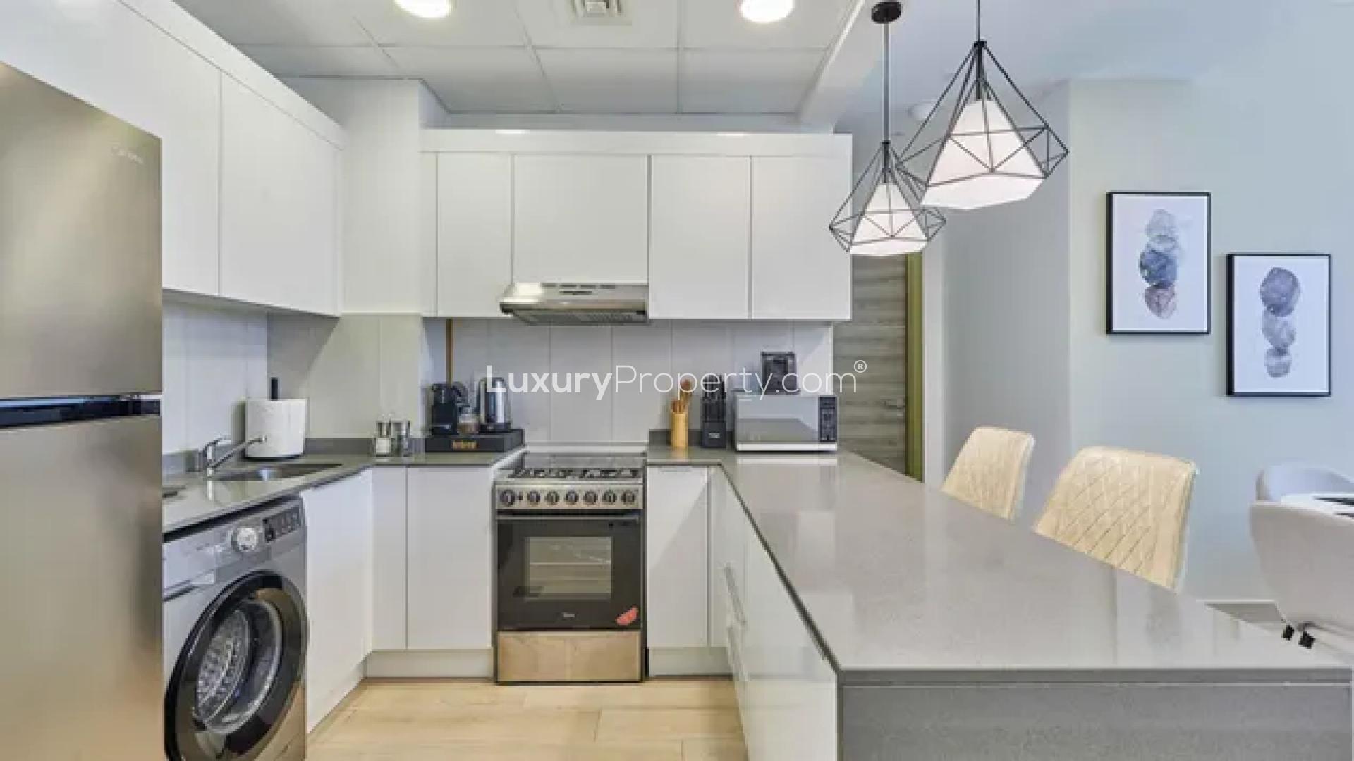 Modern dining area and kitchen in Bloom Heights apartment, Jumeirah Village Circle