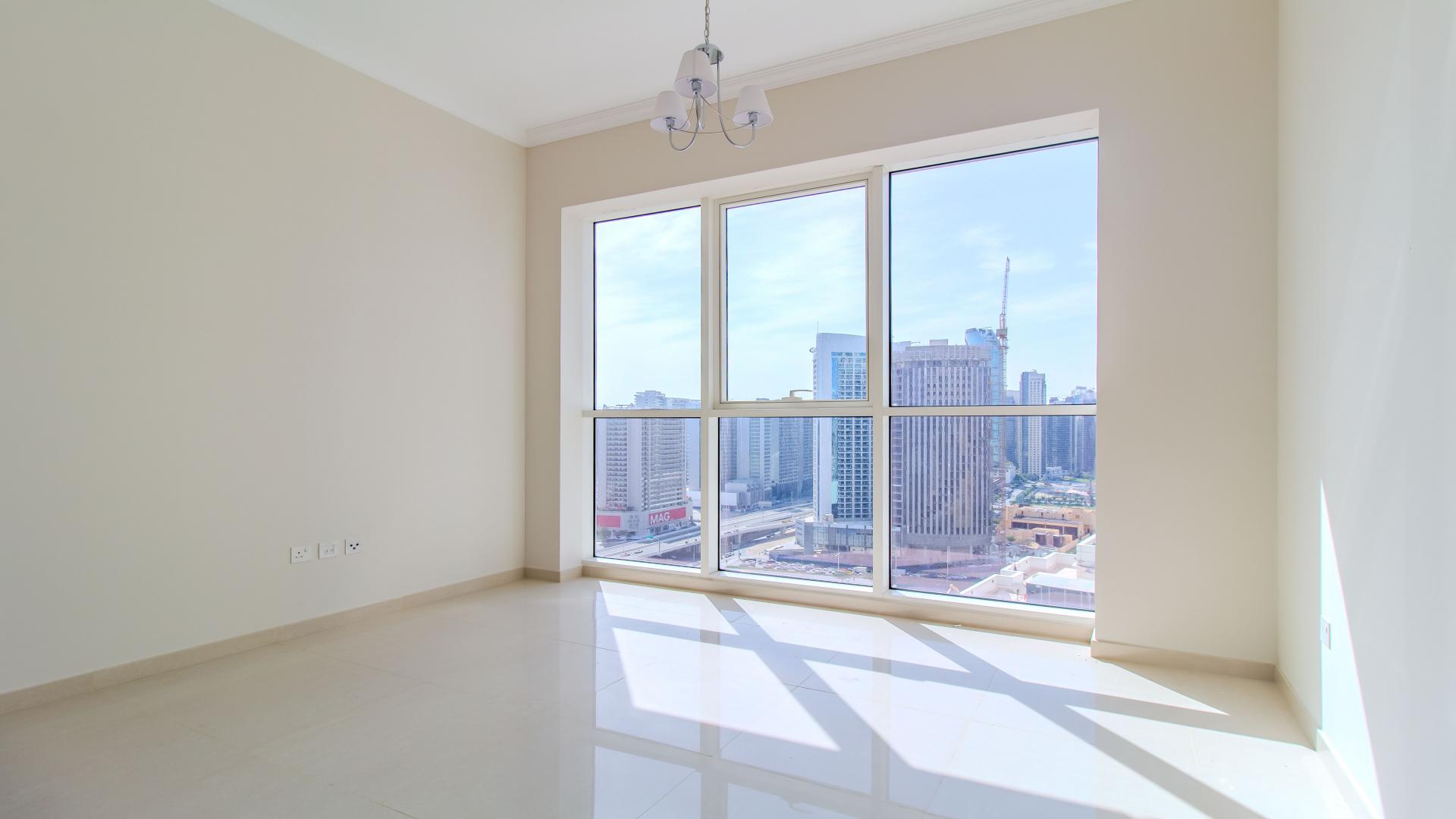 Bright living room with city view in 1-bed apartment, Dunya Tower, Downtown Dubai