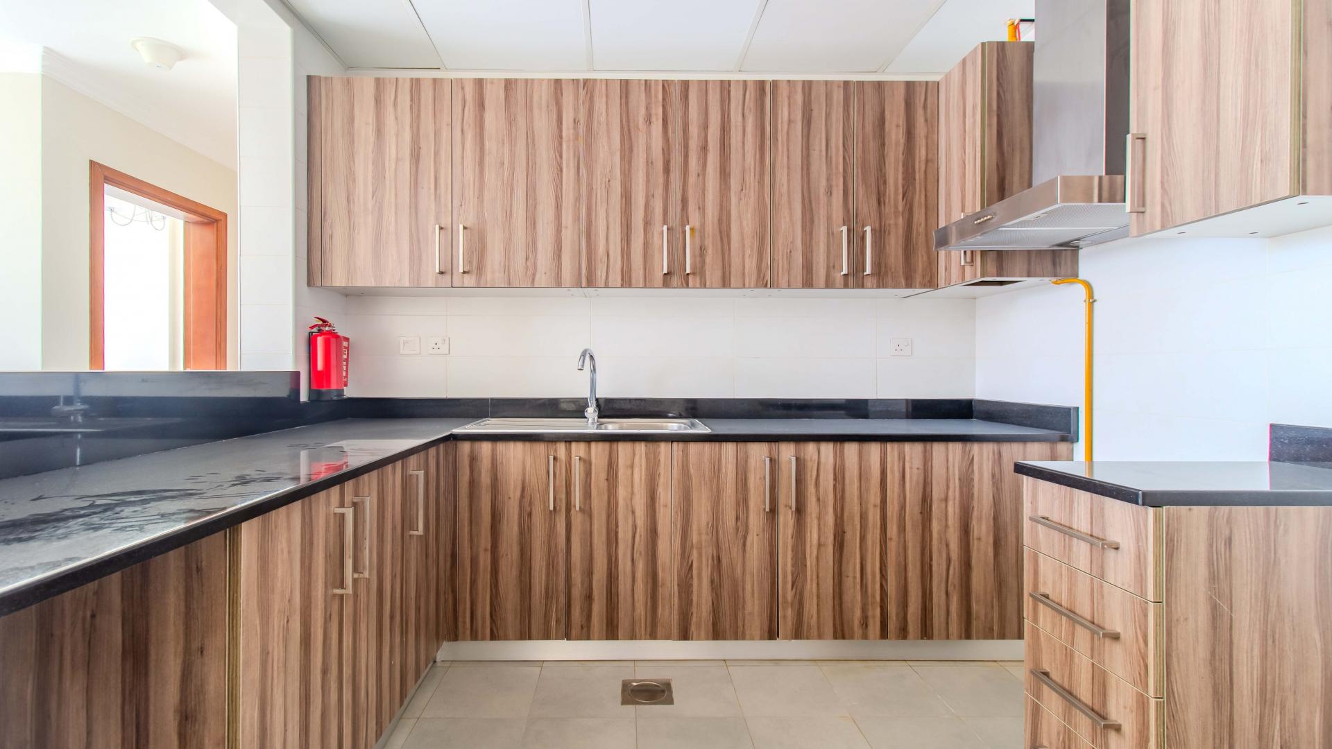 Bright living room with large windows in Dunya Tower apartment, Downtown Dubai