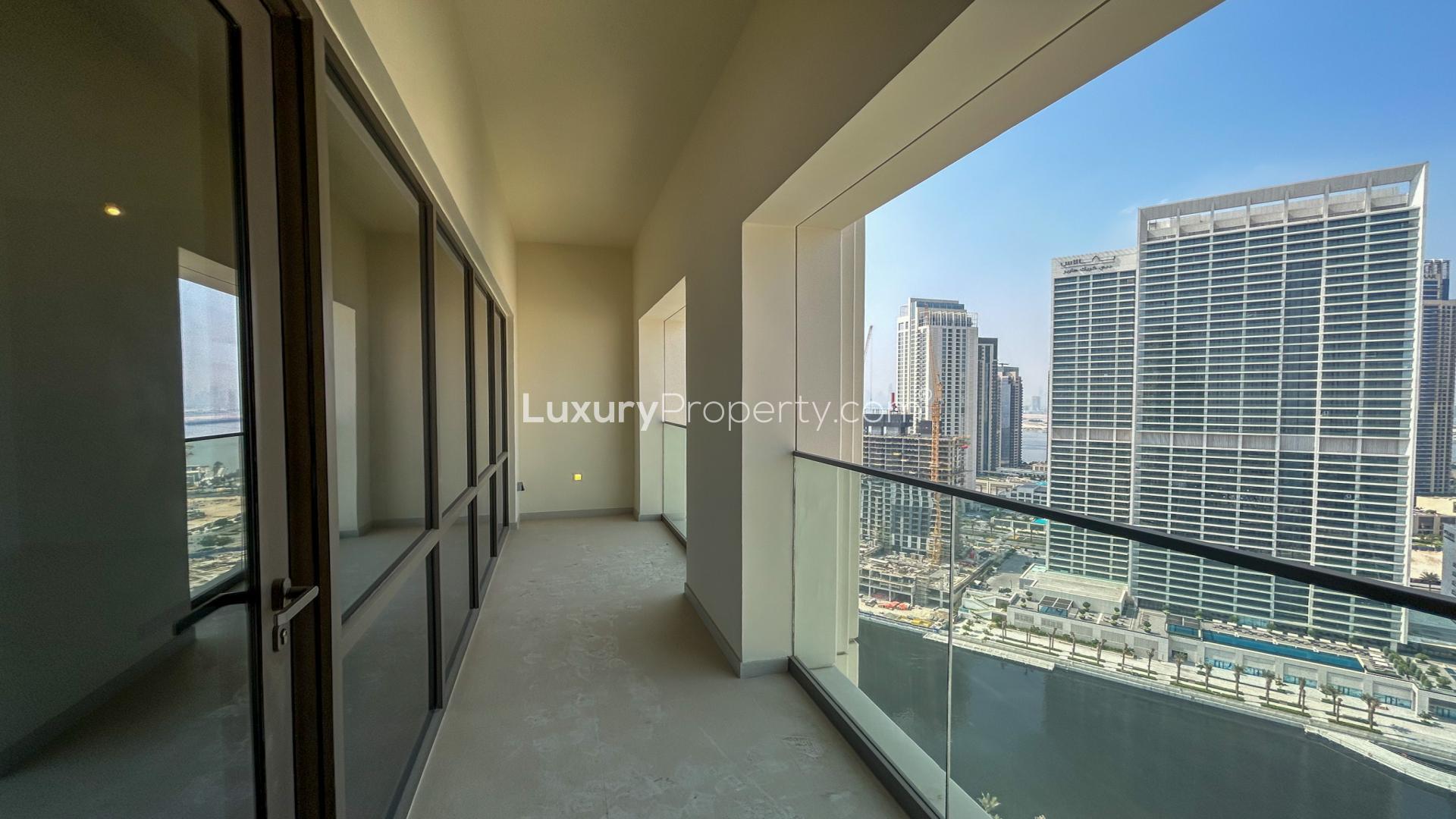 Empty living room with large window in Vida Residences, Dubai Creek Harbour apartment