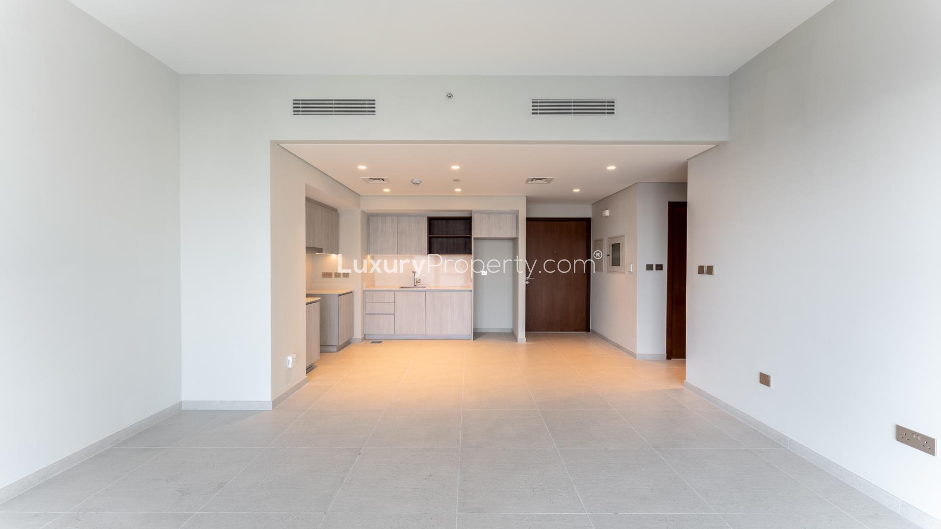 N/A,Mid-floor Dubai Creek Harbour apartment interior with modern kitchen, open layout, natural lighting