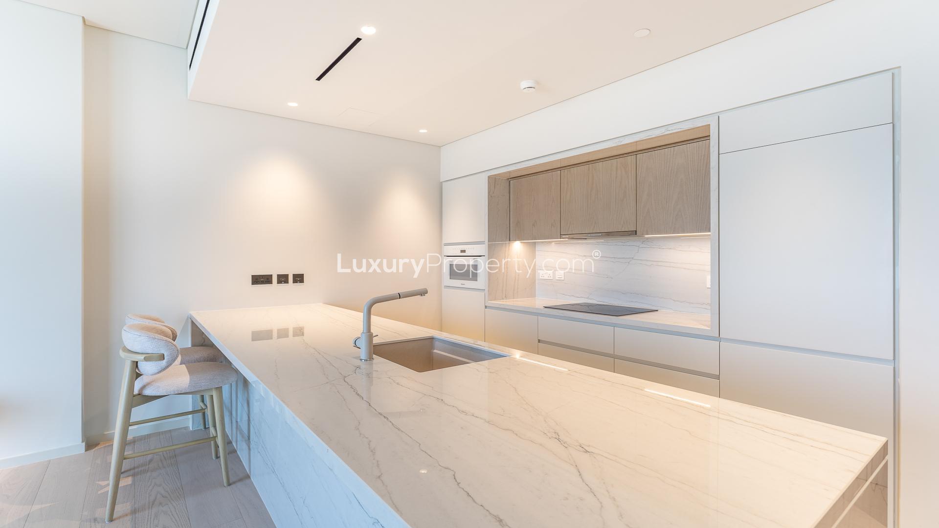 Modern studio apartment interior at Kempinski Al Jaddaf, featuring open-plan design and large windows