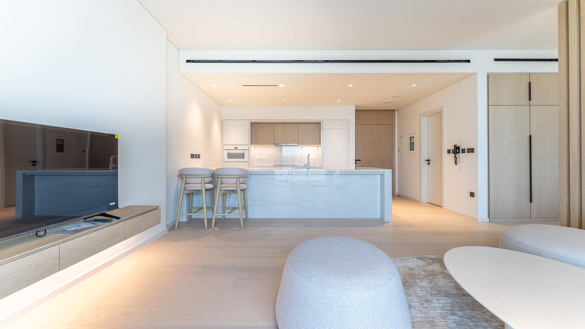 Modern studio apartment interior at Kempinski Al Jaddaf, featuring open-plan design and large windows