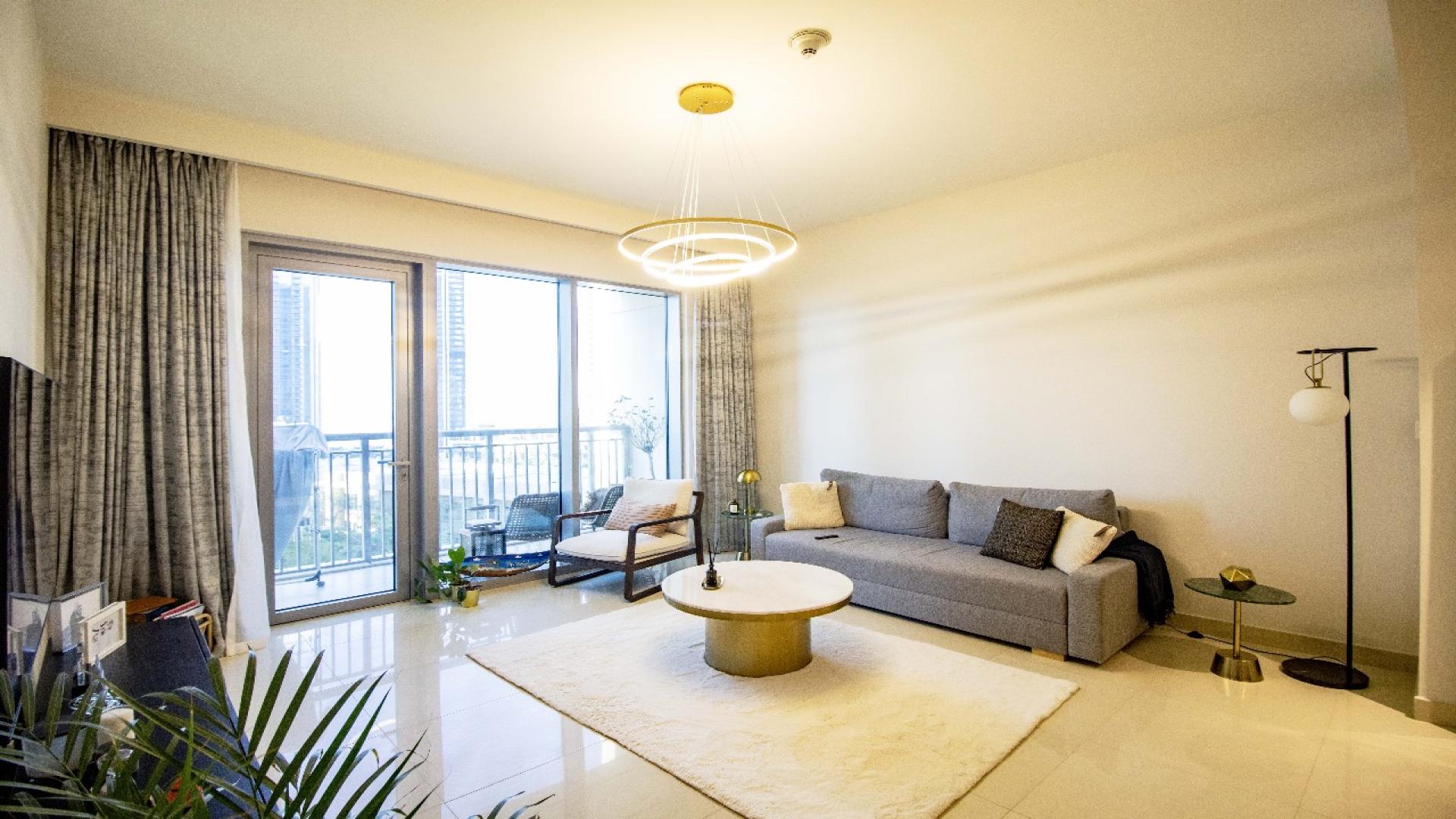 "Scenic view from Harbour Views 1 apartment, Dubai Creek Harbour, showcasing modern architecture.",Furnished living room in Harbour Views 1, Dubai Creek Harbour apartment for sale