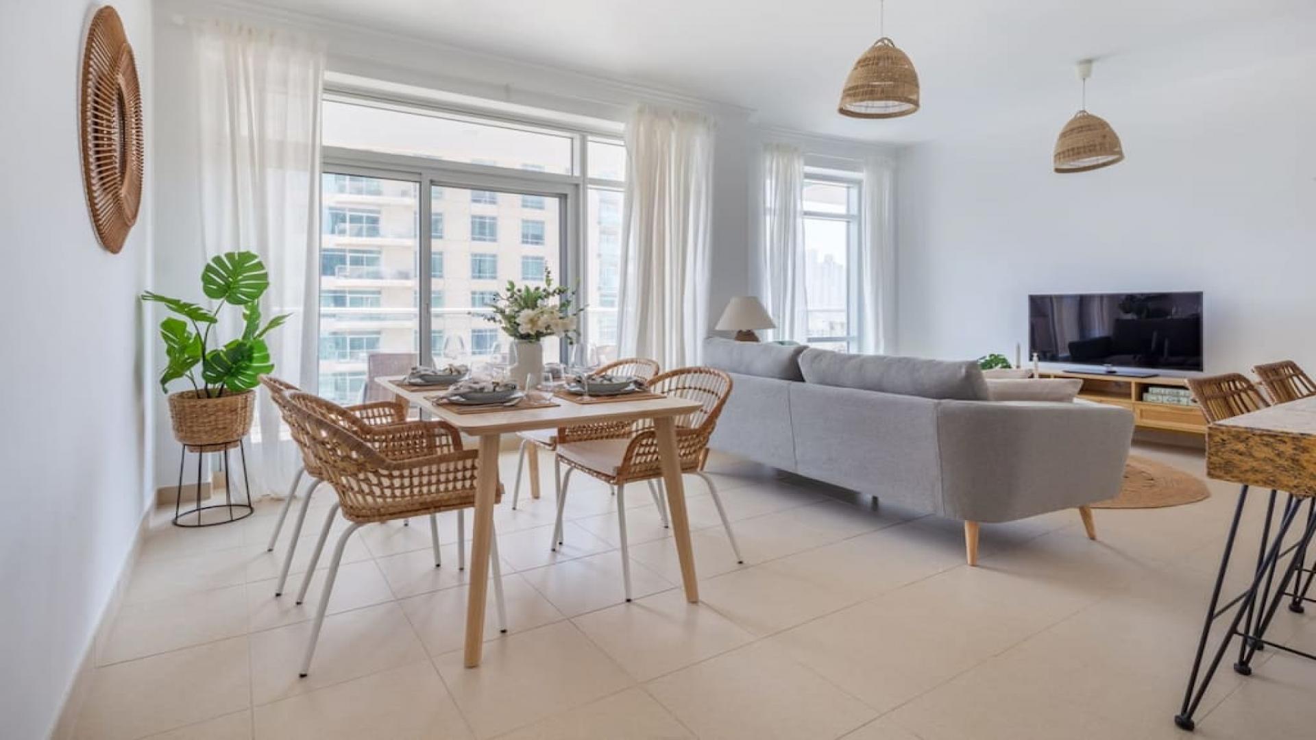 Furnished living room with large windows in Downtown Dubai apartment, Burj Views community