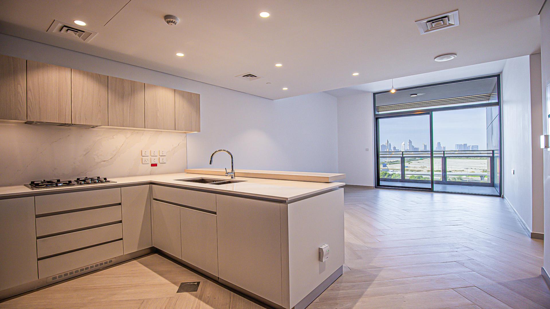 "Modern kitchen in Wilton Park Residences apartment, sleek design with built-in appliances.",Modern kitchen with Burj Khalifa view in Wilton Park Residences apartment, Mohammed Bin Rashid City