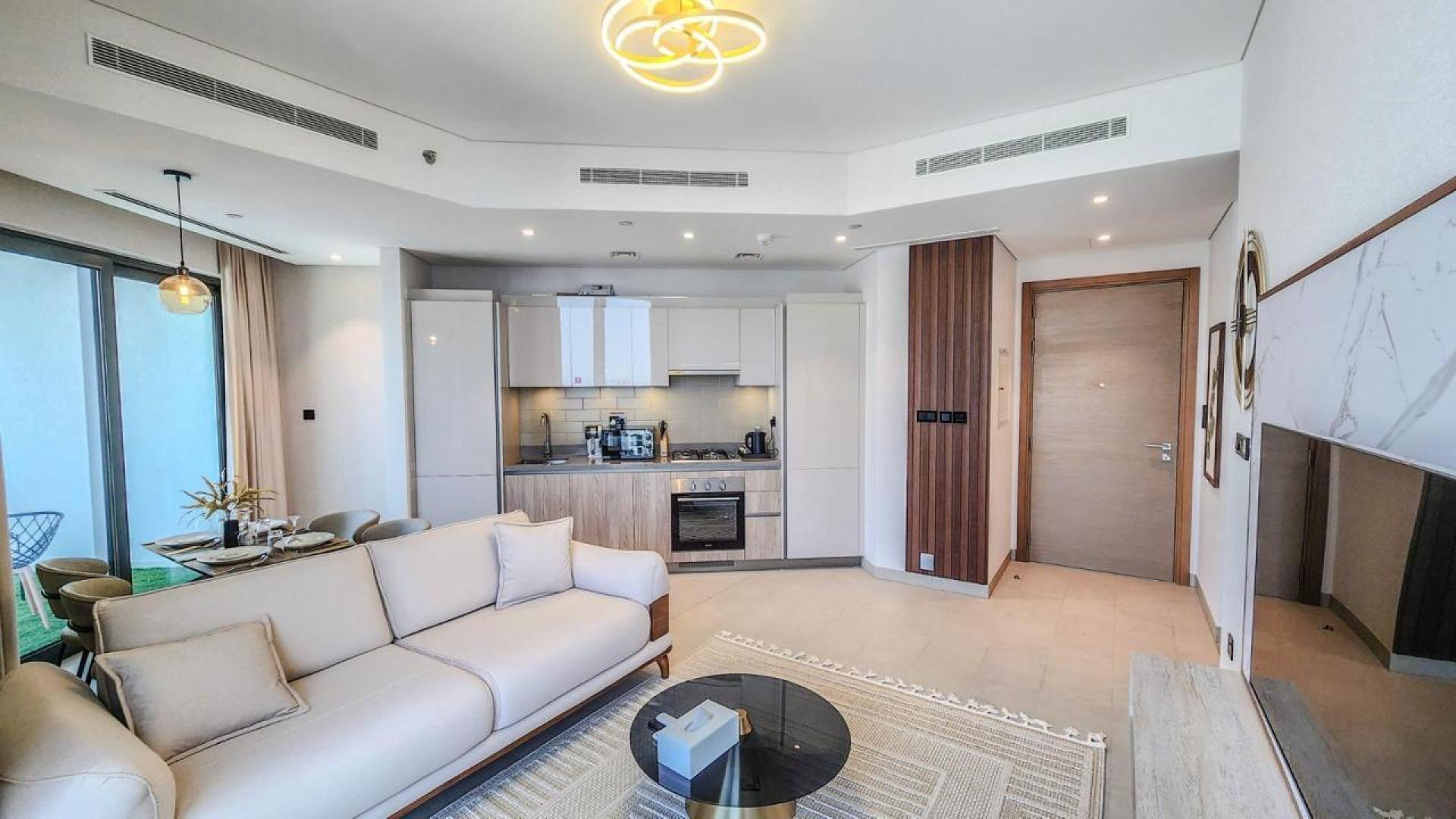 Modern bedroom in Sobha Hartland apartment, featuring large window with city view