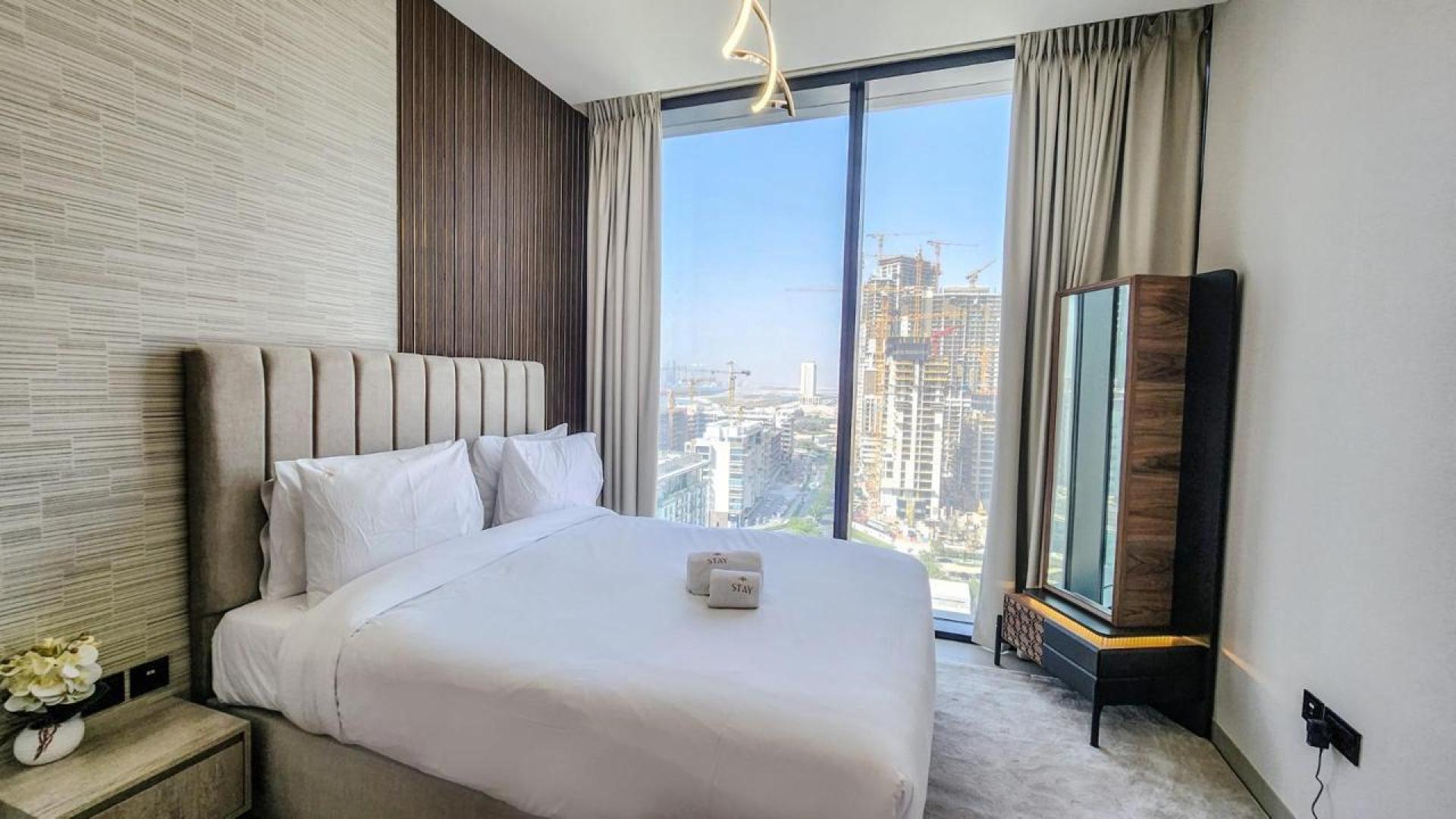 Modern living room in Sobha Hartland apartment, featuring city view and elegant decor