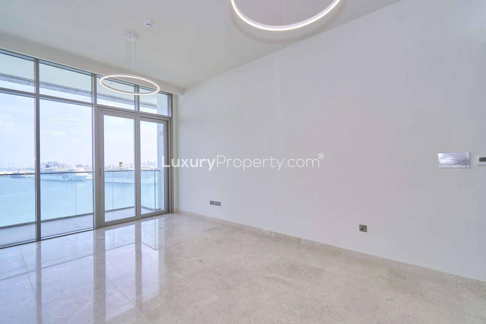 "Bright apartment with large windows overlooking Dubai Maritime City waterfront in Anwa.",Bright living area with sea view in Anwa, Dubai Maritime City apartment for sale