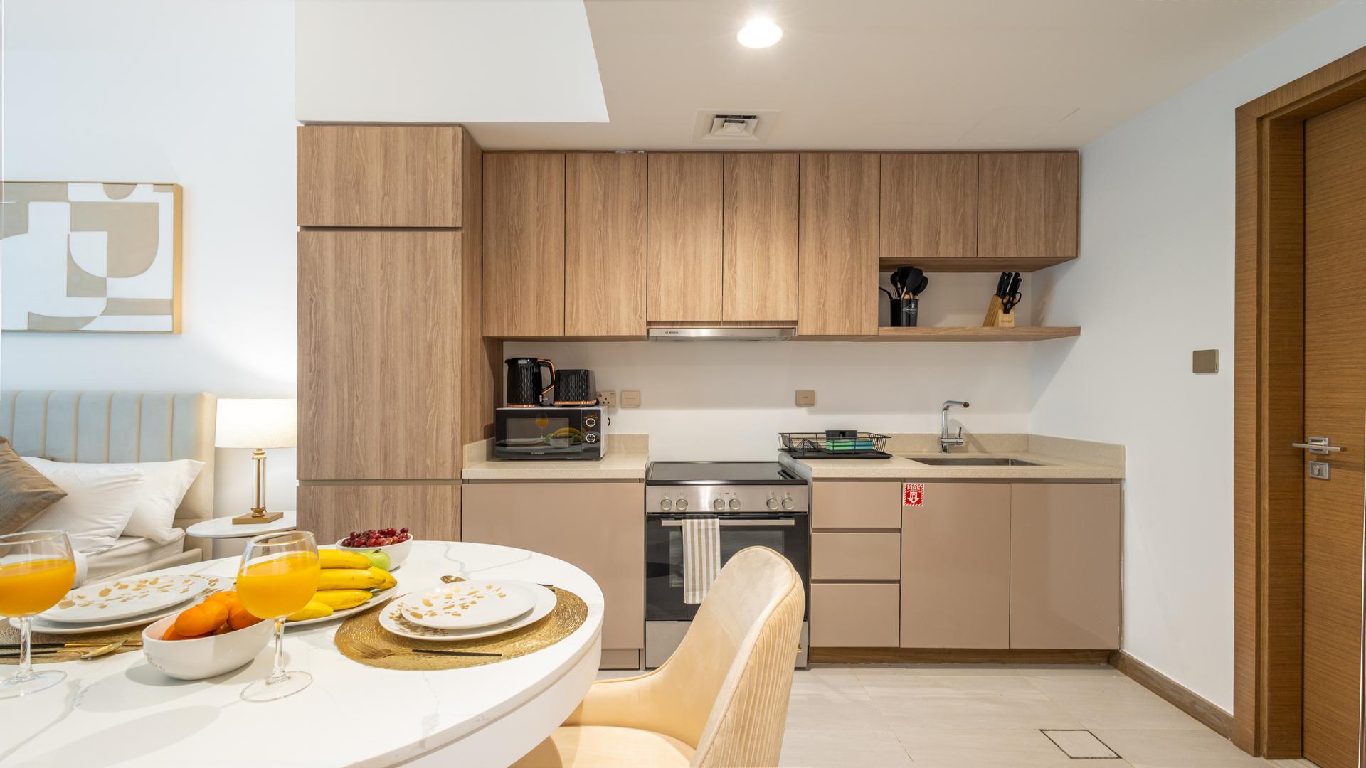 Brand new studio apartment interior in Urban Oasis, Business Bay with modern kitchen and dining area