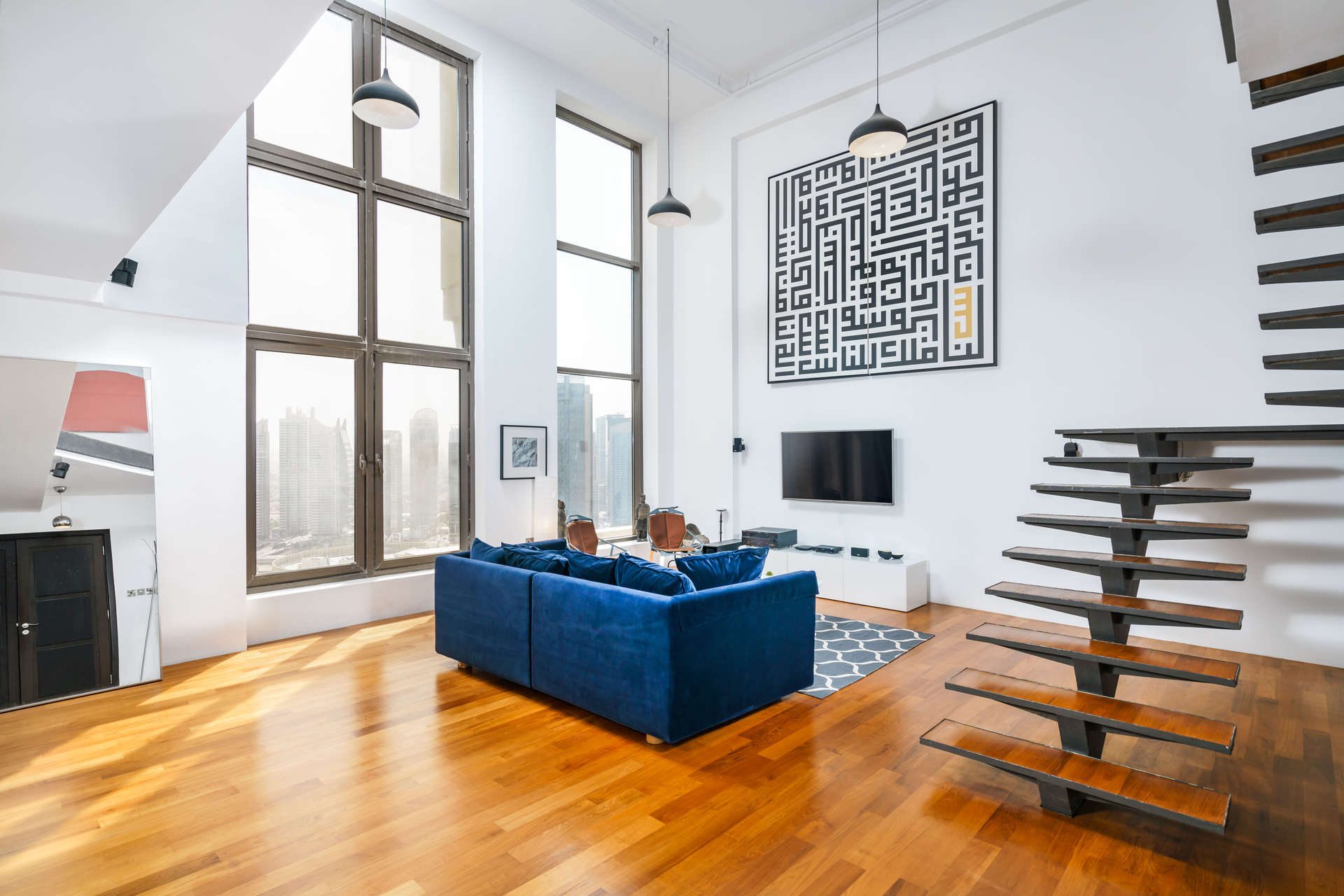 Elegant loft apartment interior with large windows in Bahar 6, Jumeirah Beach Residence