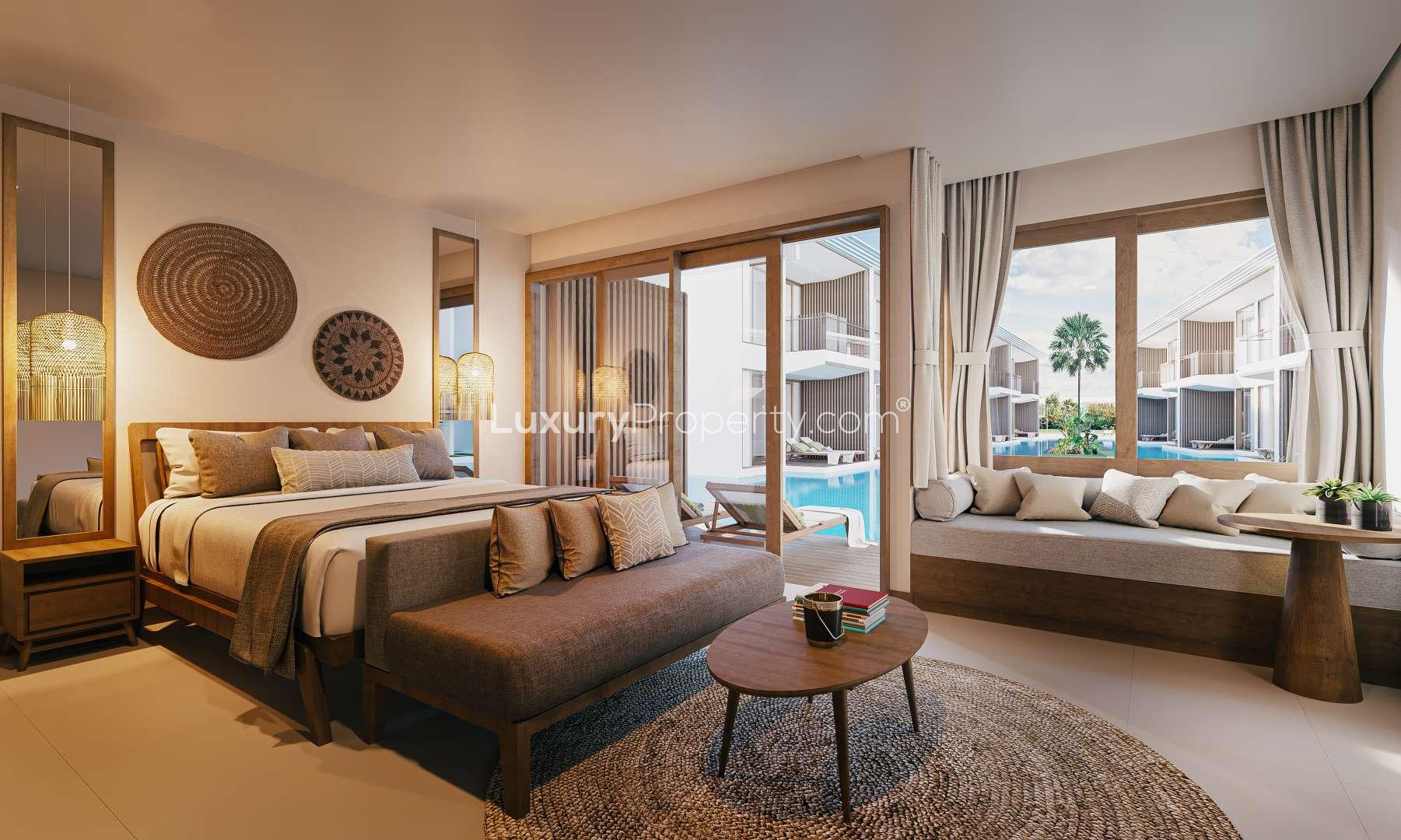 1-Bedroom Lagoon Suite balcony with sun loungers at Cocana Resort, Bali