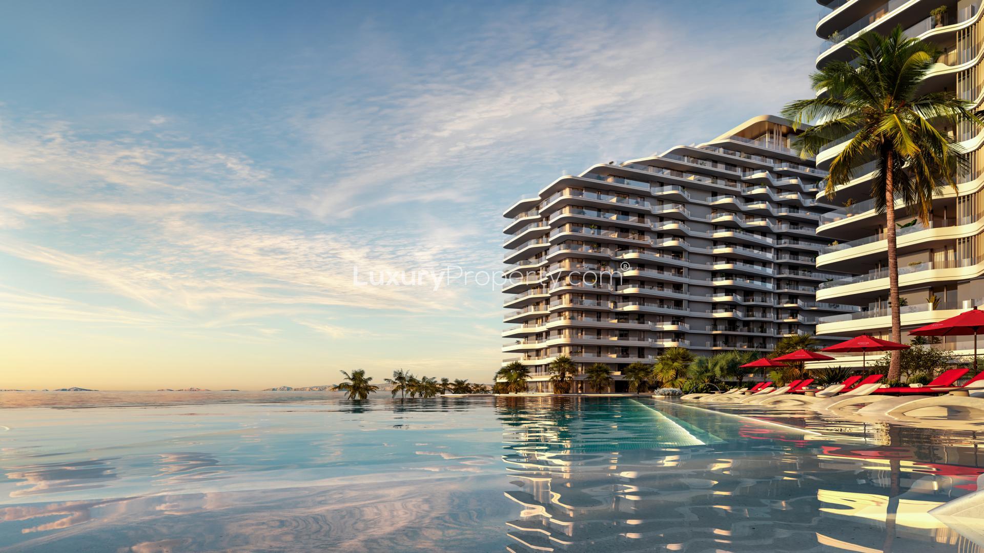 Al Marjan Island Rosso Residences apartment exterior with pool and palm trees at sunset