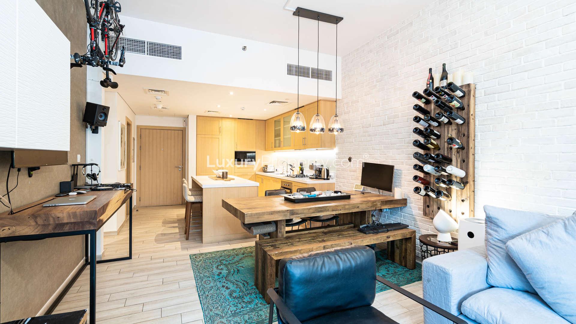 Outdoor pool area at Belgravia III, JVC apartment complex with lush landscaping and loungers