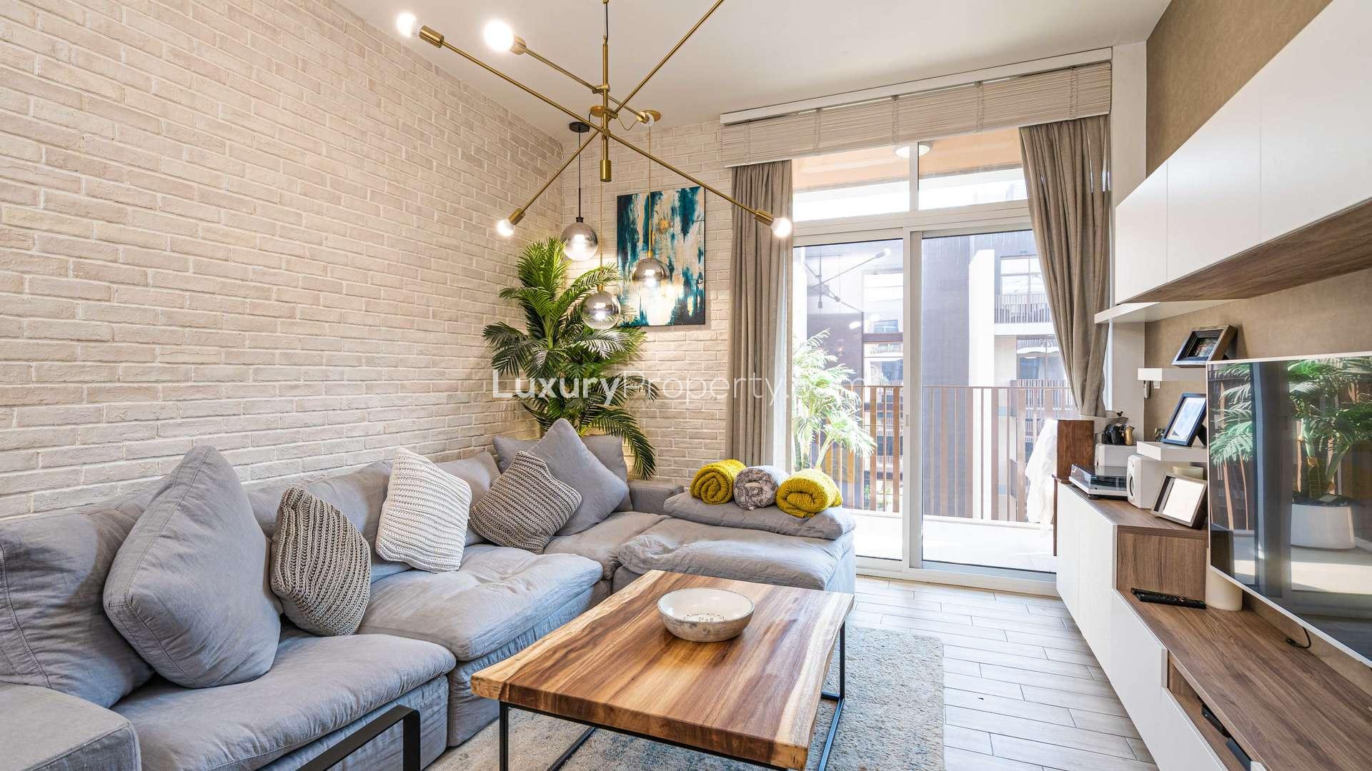 Modern kitchen and living area in Belgravia III apartment, JVC, with sleek design elements